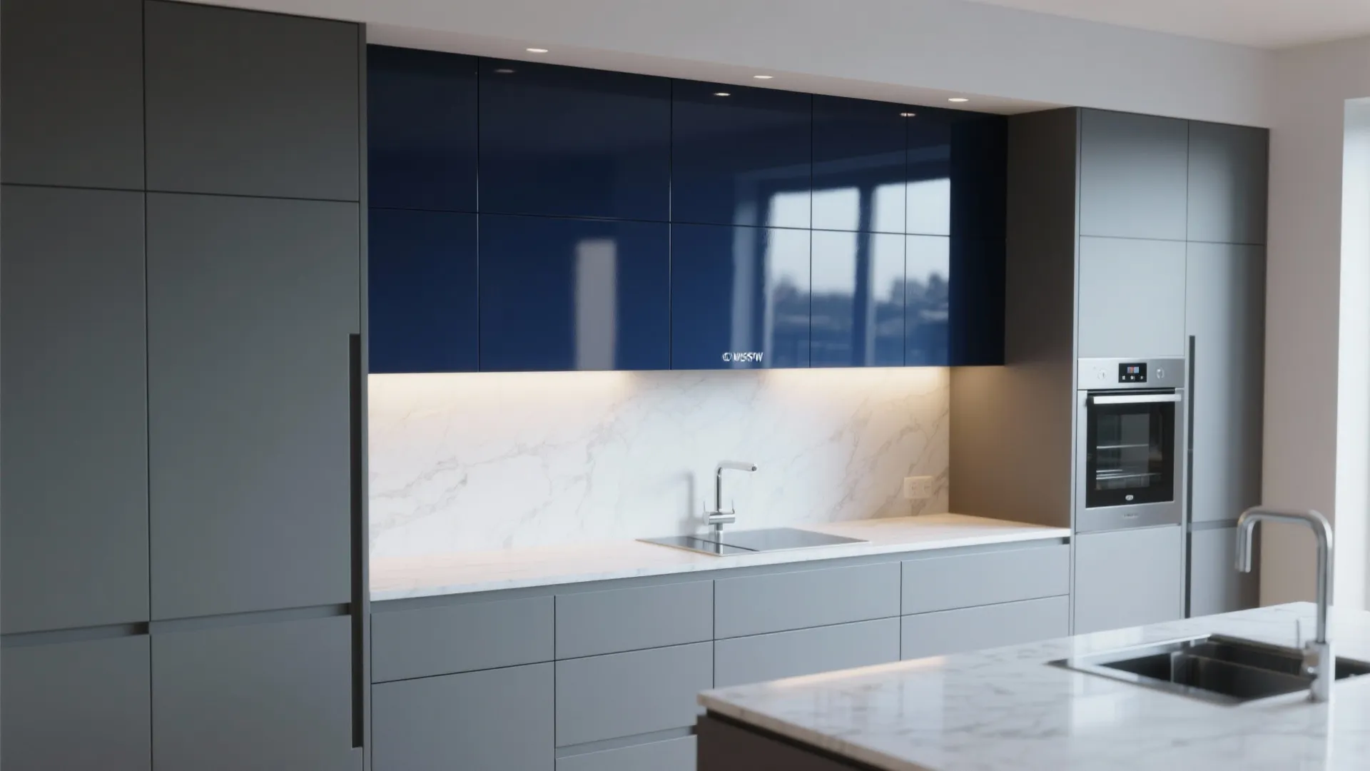 Modern kitchen with glossy navy blue upper cabinets, grey lower cabinets and white marble backsplash