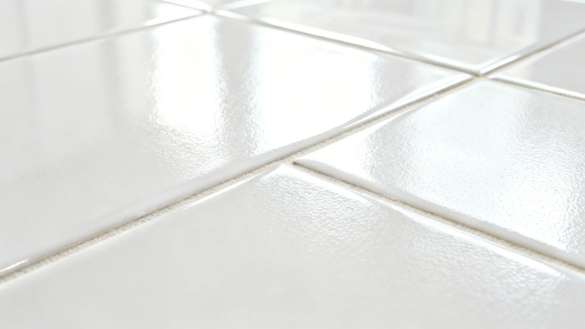 Macro of glossy white porcelain tile with subtle texture and clean grout.