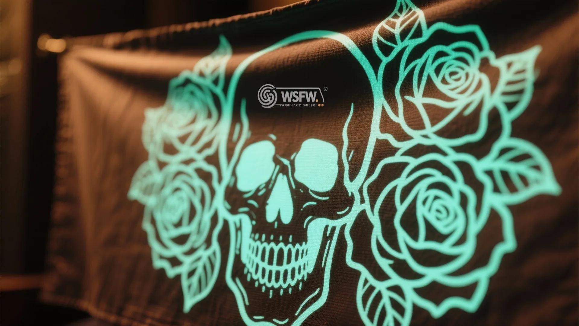 Black fabric wall hanging with glowing green skull design surrounded by roses and decorative leaves