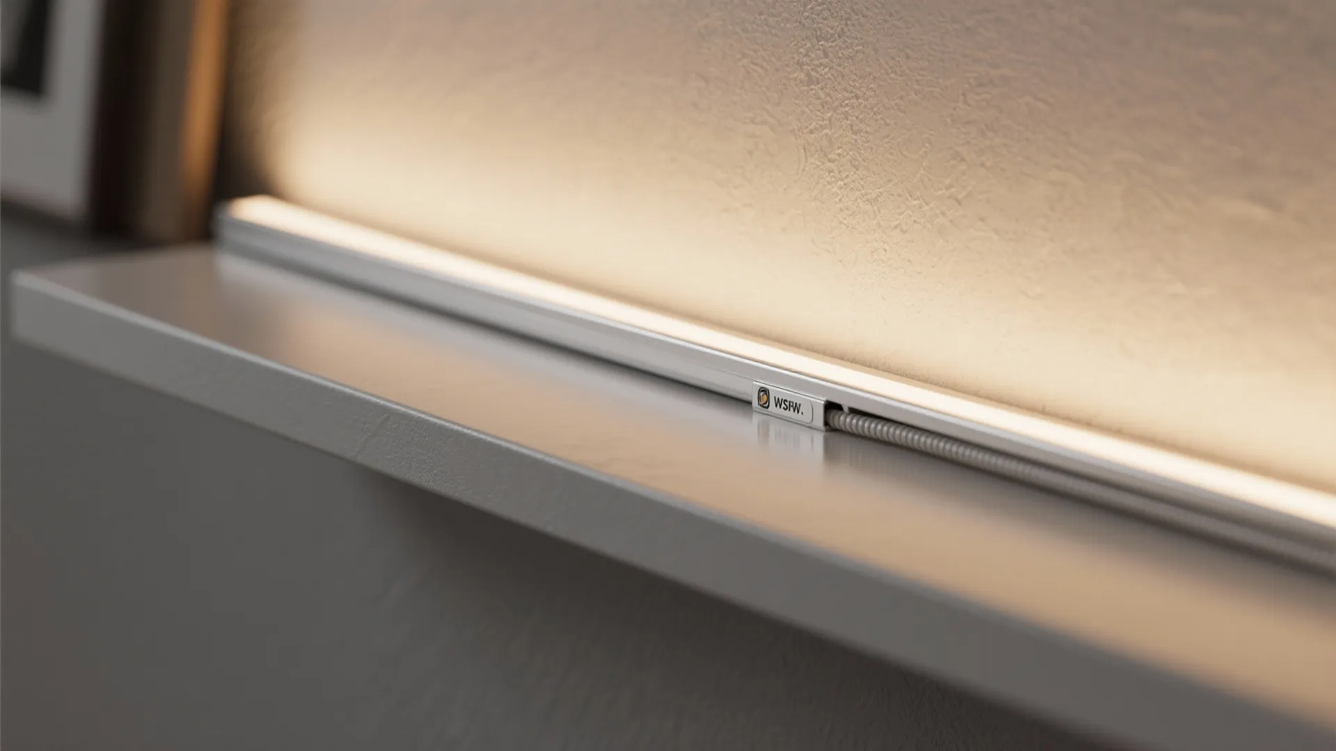 Close up of warm led light strip installed on a white shelf against a wall