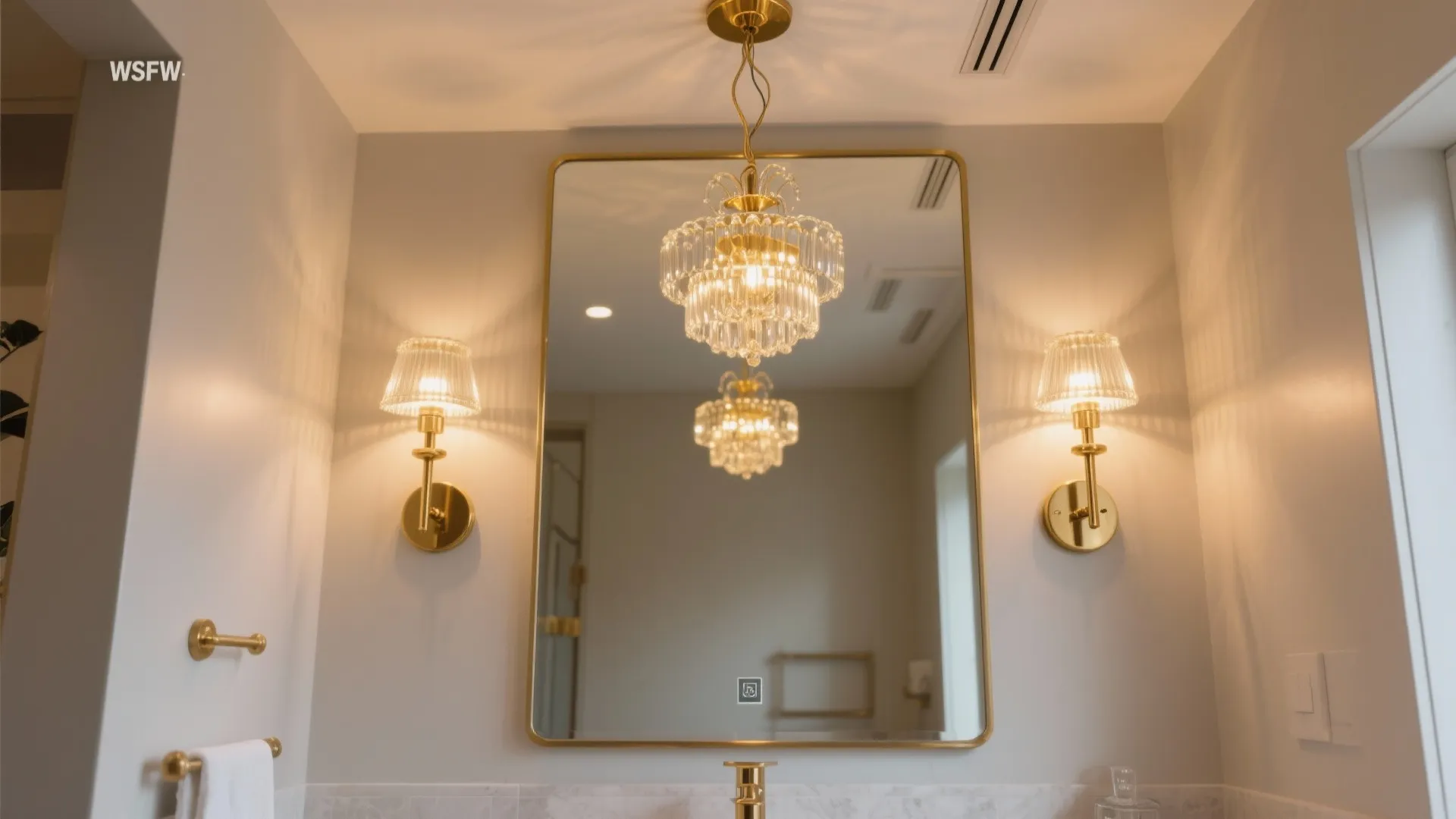 Luxury bathroom with gold frame mirror glass ceiling light and two matching gold wall lights