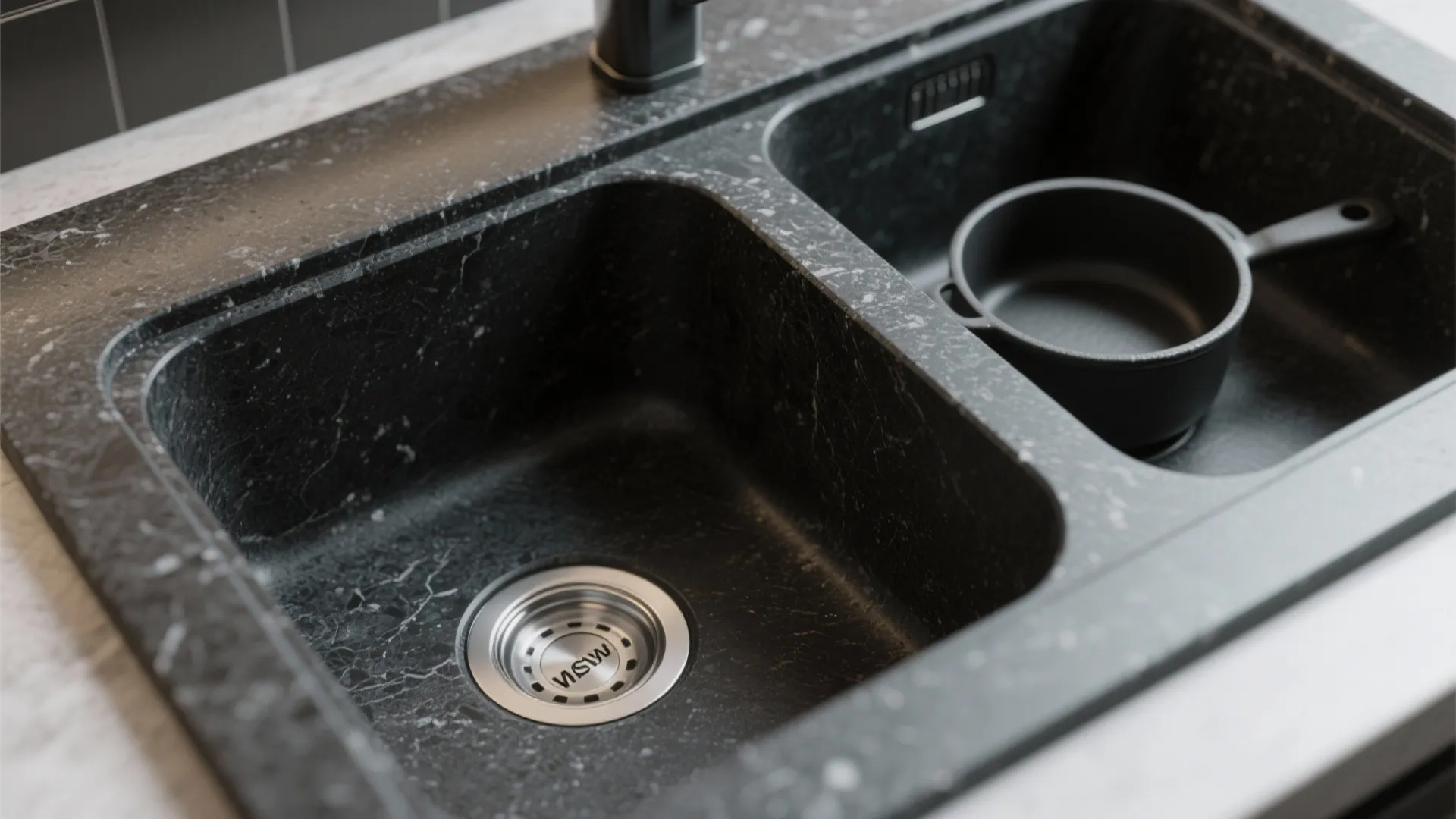Macro view of a granite composite matte black sink interior showing textured surface and durability.