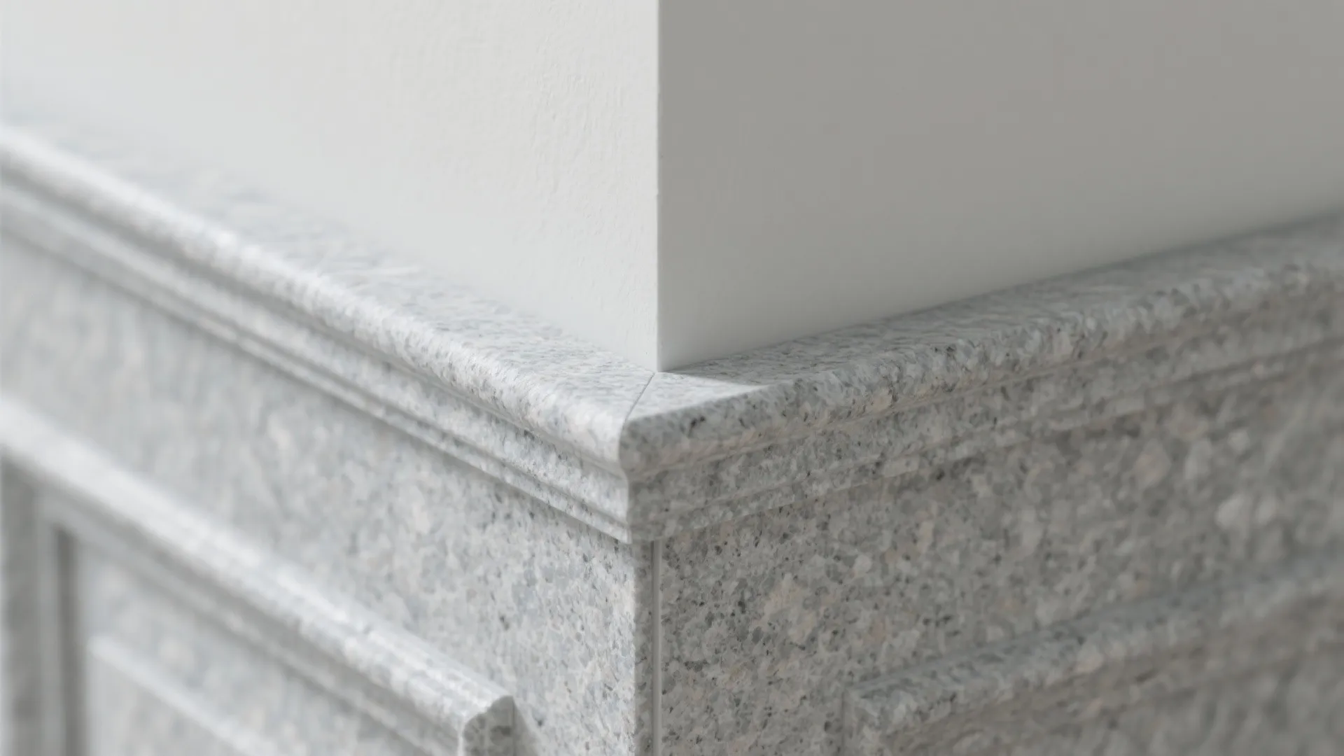 Close up view of a grey stone wall panel meeting a white wall at a corner
