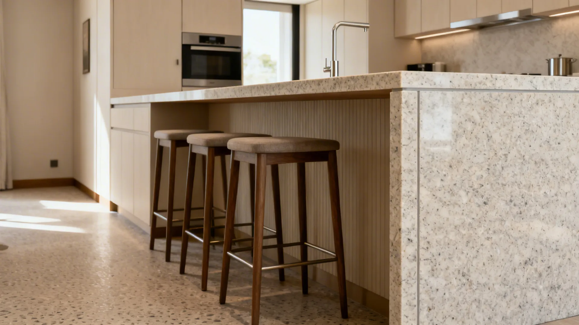 Compact kitchen peninsula with a light granite waterfall edge and clear aisle space.