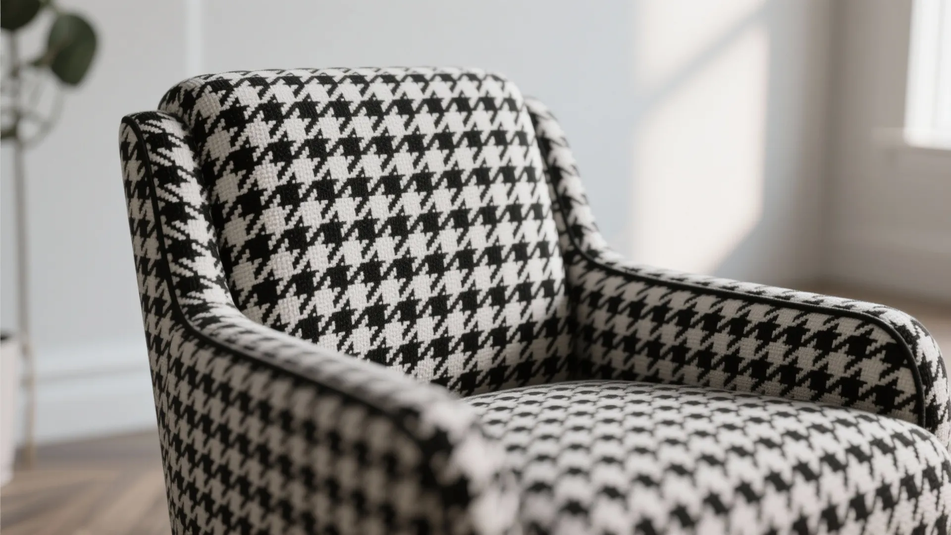 Close-up of a comfortable chair with black and white graphic pattern fabric in a room