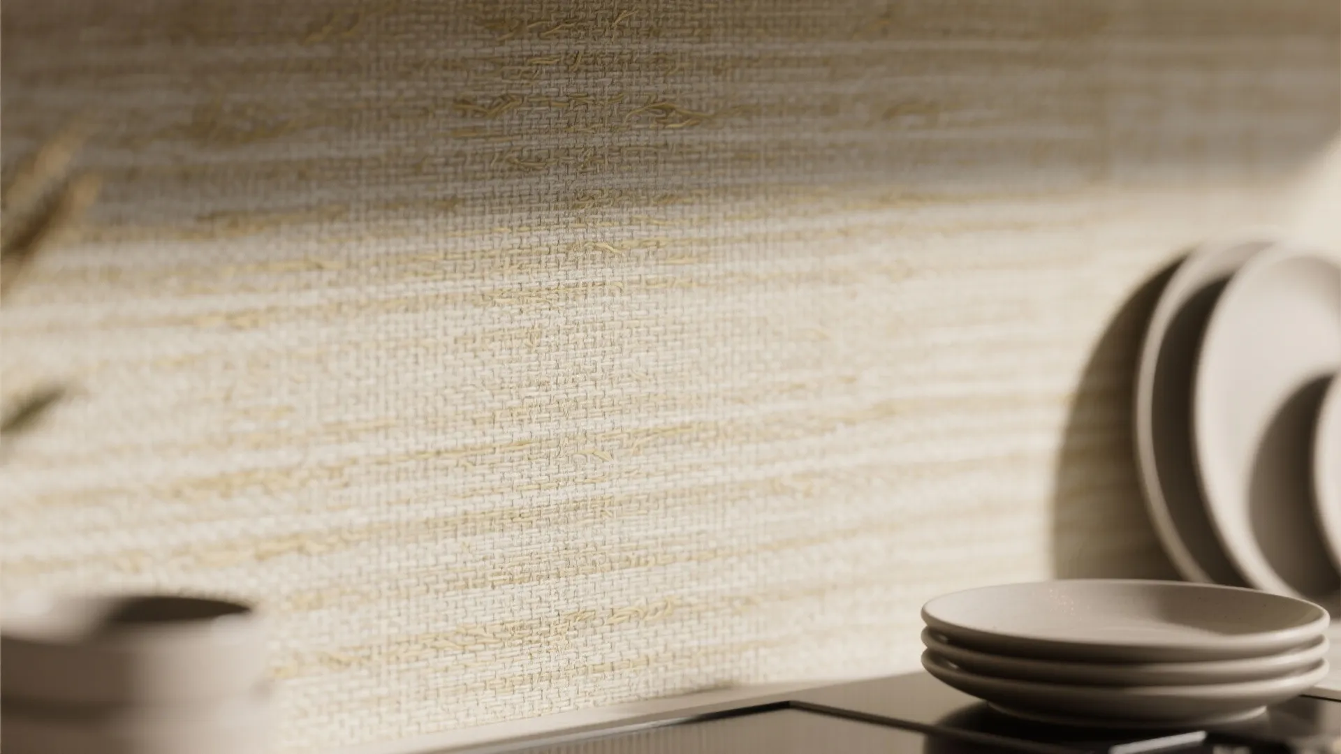 Close-up of a textured beige kitchen wall with woven fabric pattern and white ceramic plates