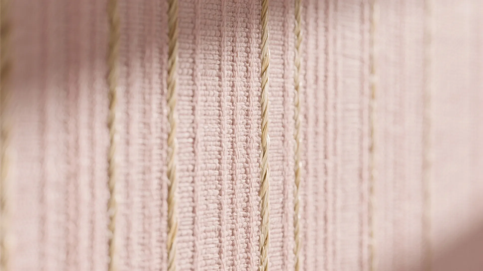 Close up view of pink textured wallpaper with vertical beige lines for interior wall design