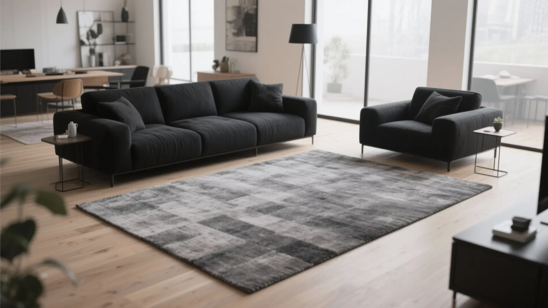 Spacious living room featuring a large grey rug black sofa and natural wood floor design
