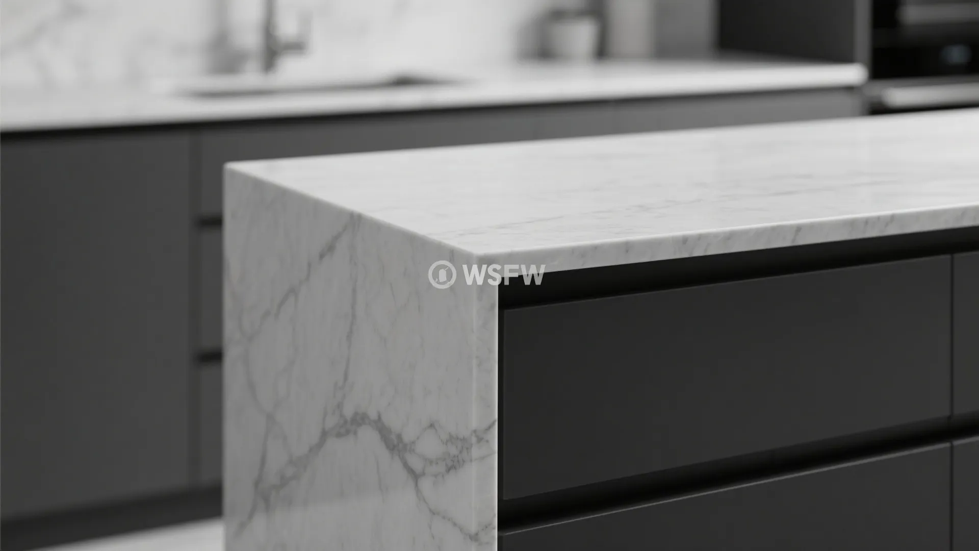 Close up of a white marble kitchen island with gray veins and dark gray storage cabinets