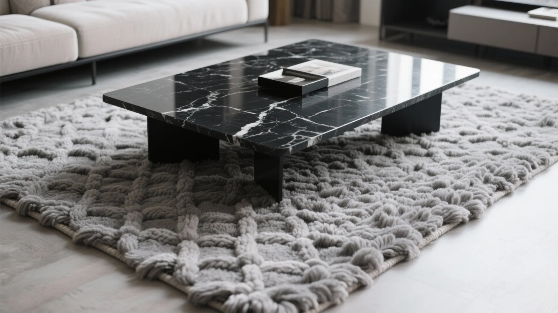 Gray wool rug under a black marble coffee table