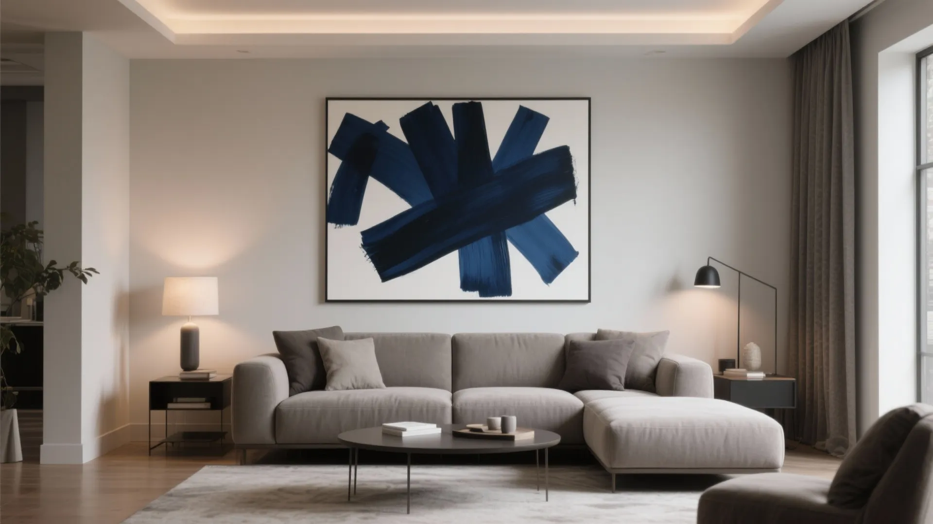 Modern living room featuring grey sofa large navy blue wall art round coffee table and lamps
