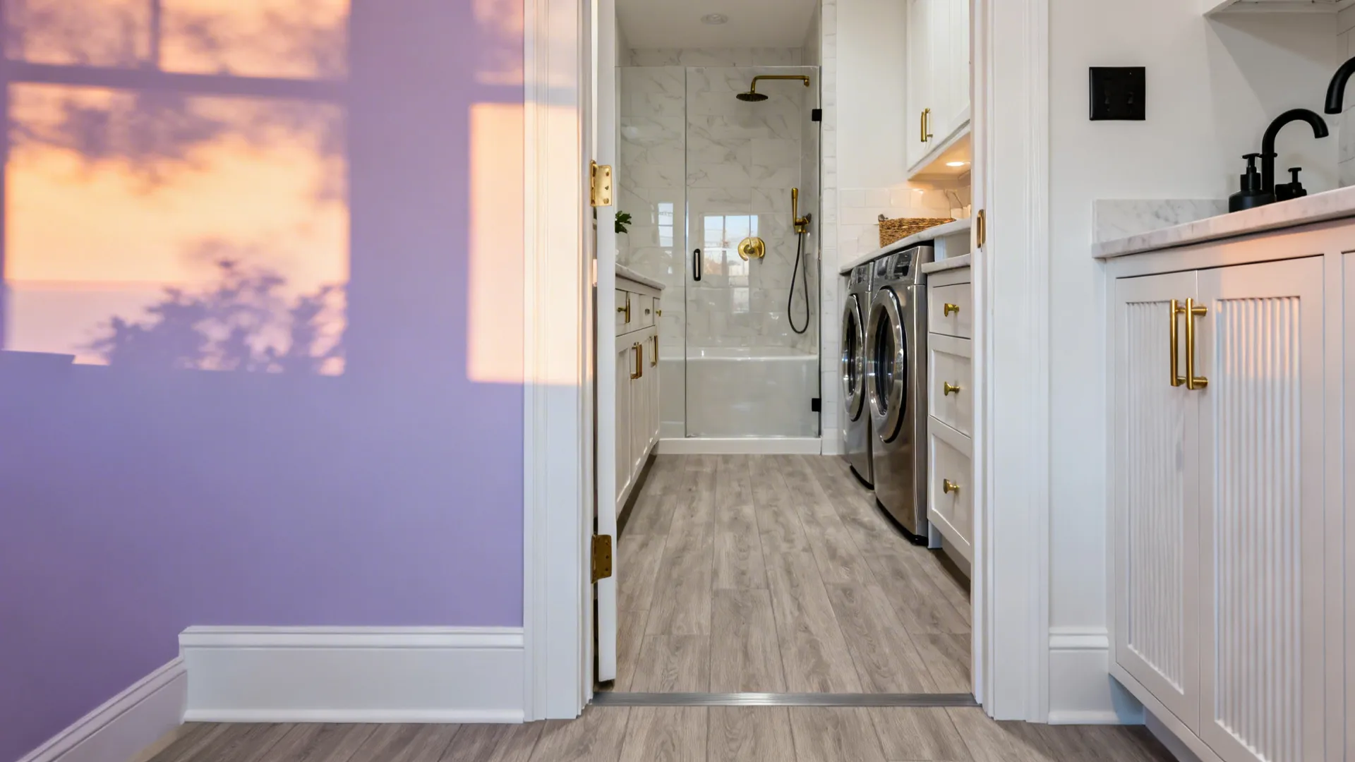 Greige ash vinyl floor flows from a compact kitchen to a laundry and shower area.