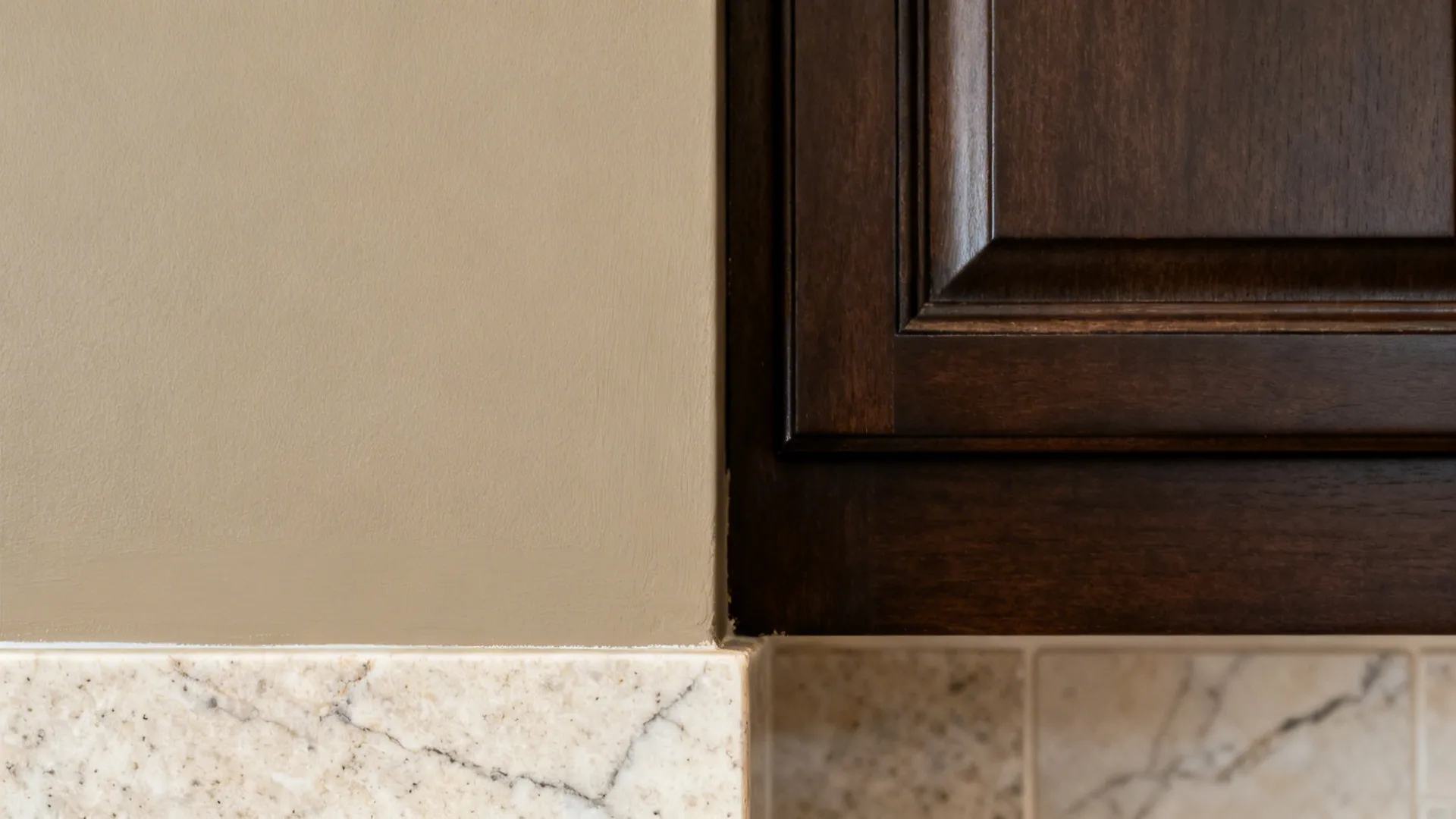 Macro swatches of warm greige against espresso cabinet and light stone countertop.