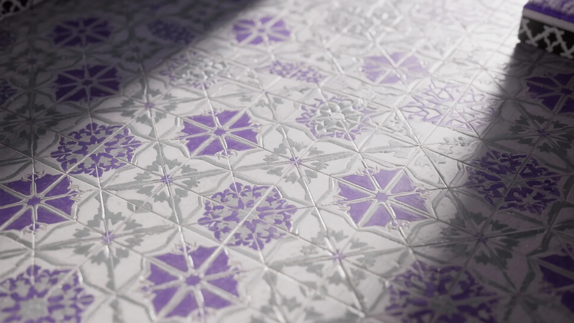 Close up view of floor tiles featuring purple and grey geometric patterns with natural indoor lighting