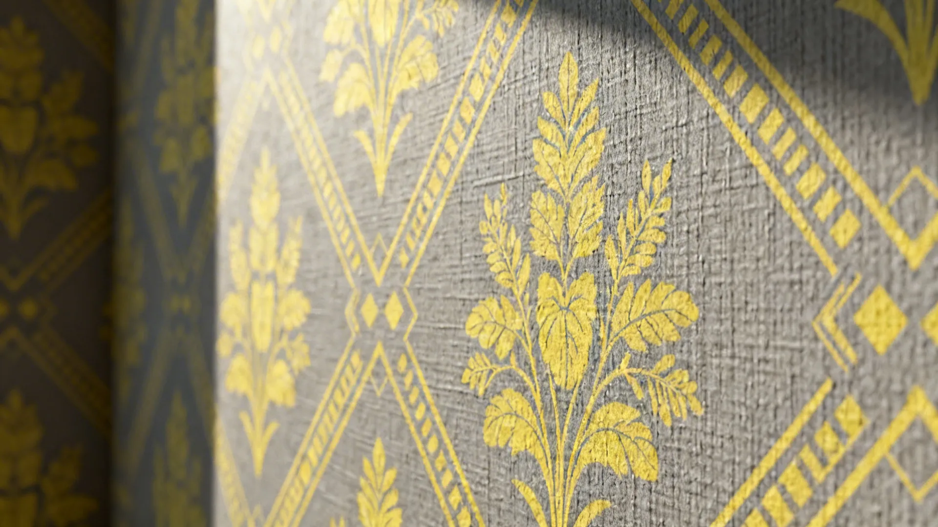 Grey wallpaper with yellow botanical motifs shown in close-up to reveal texture and scale.