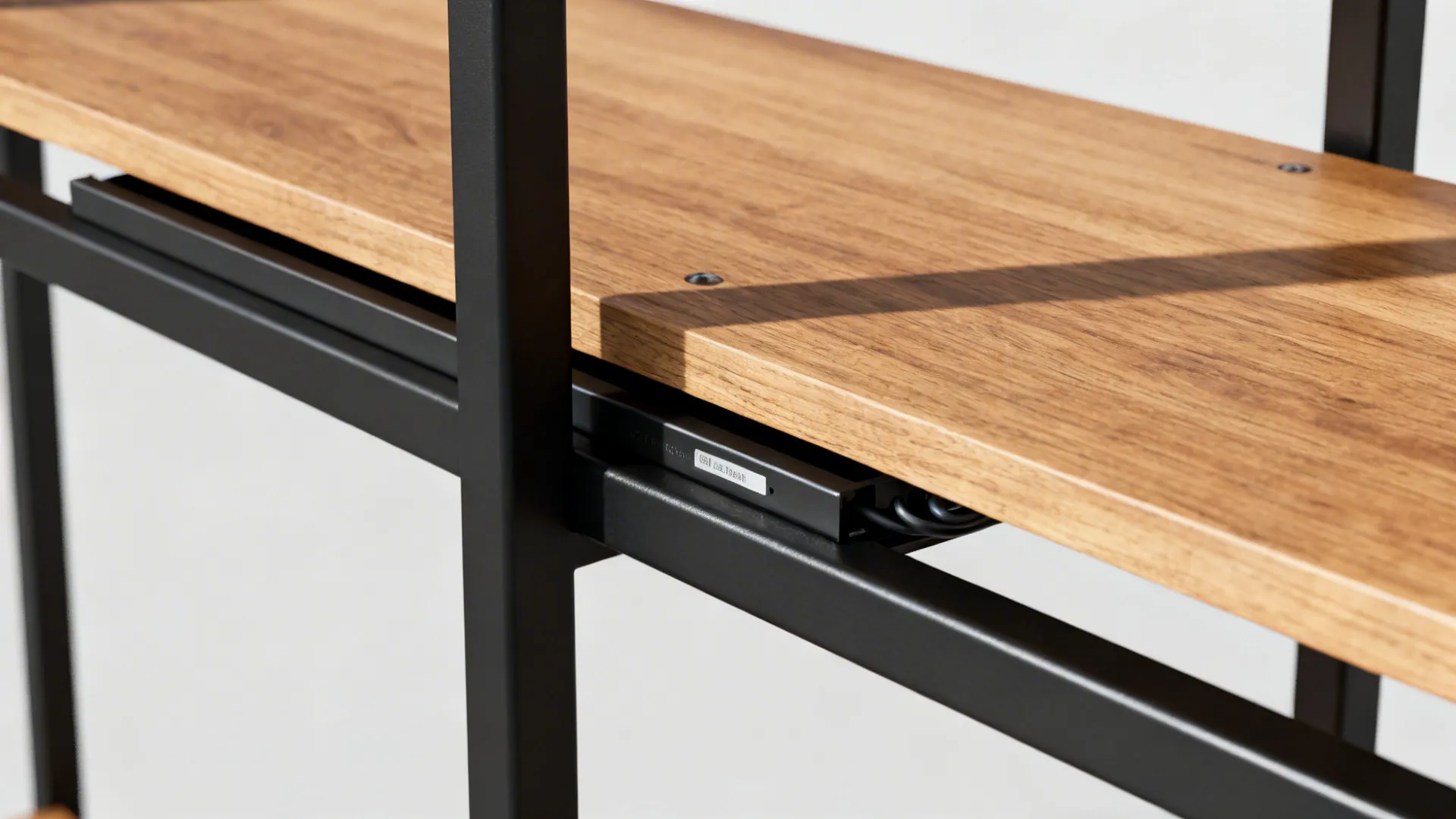 Close up view of a wooden shelf board attached to a black metal frame support structure