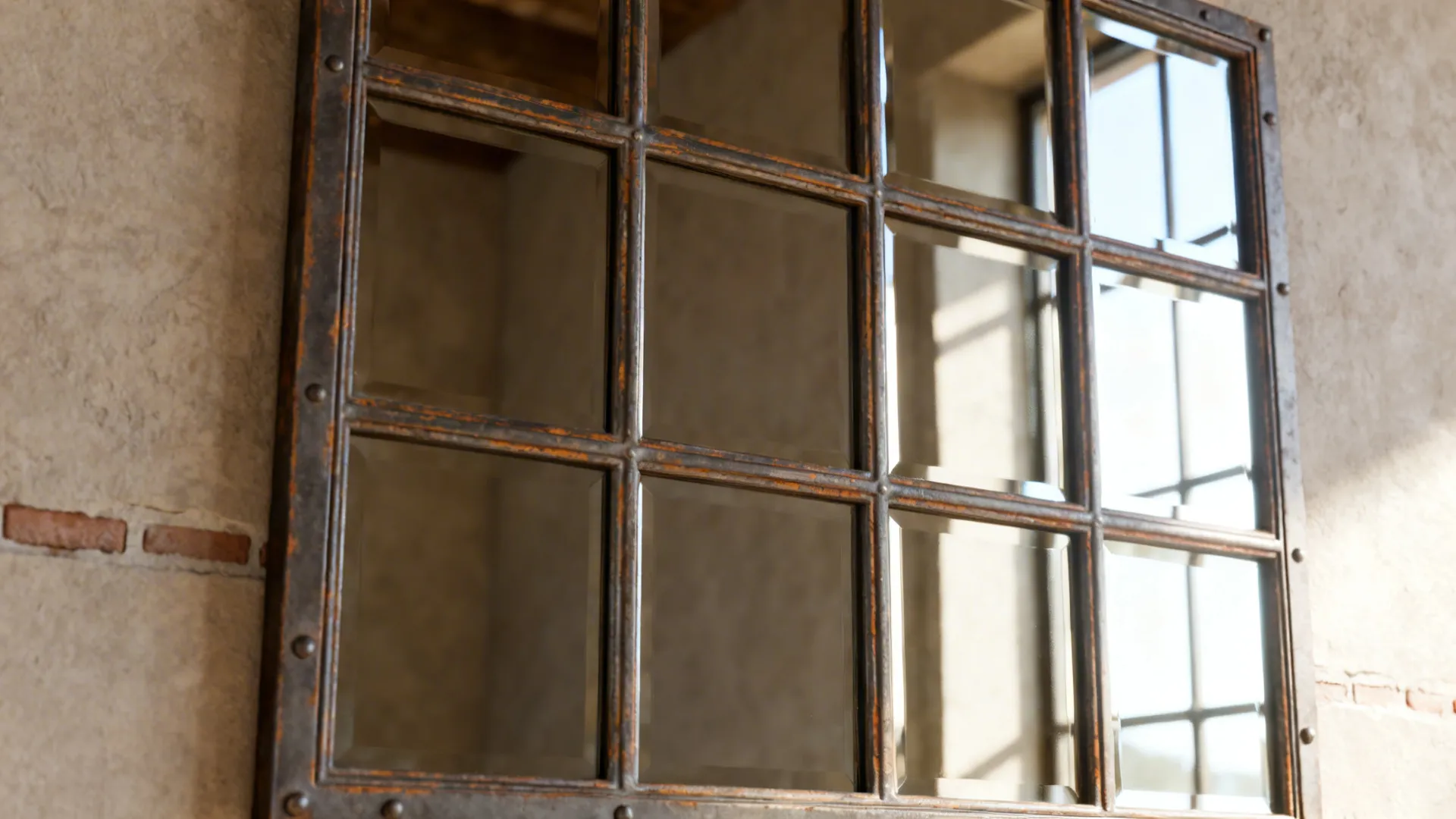 Close-up of a multi-pane grid rectangular mirror with industrial farmhouse frame and reflected light