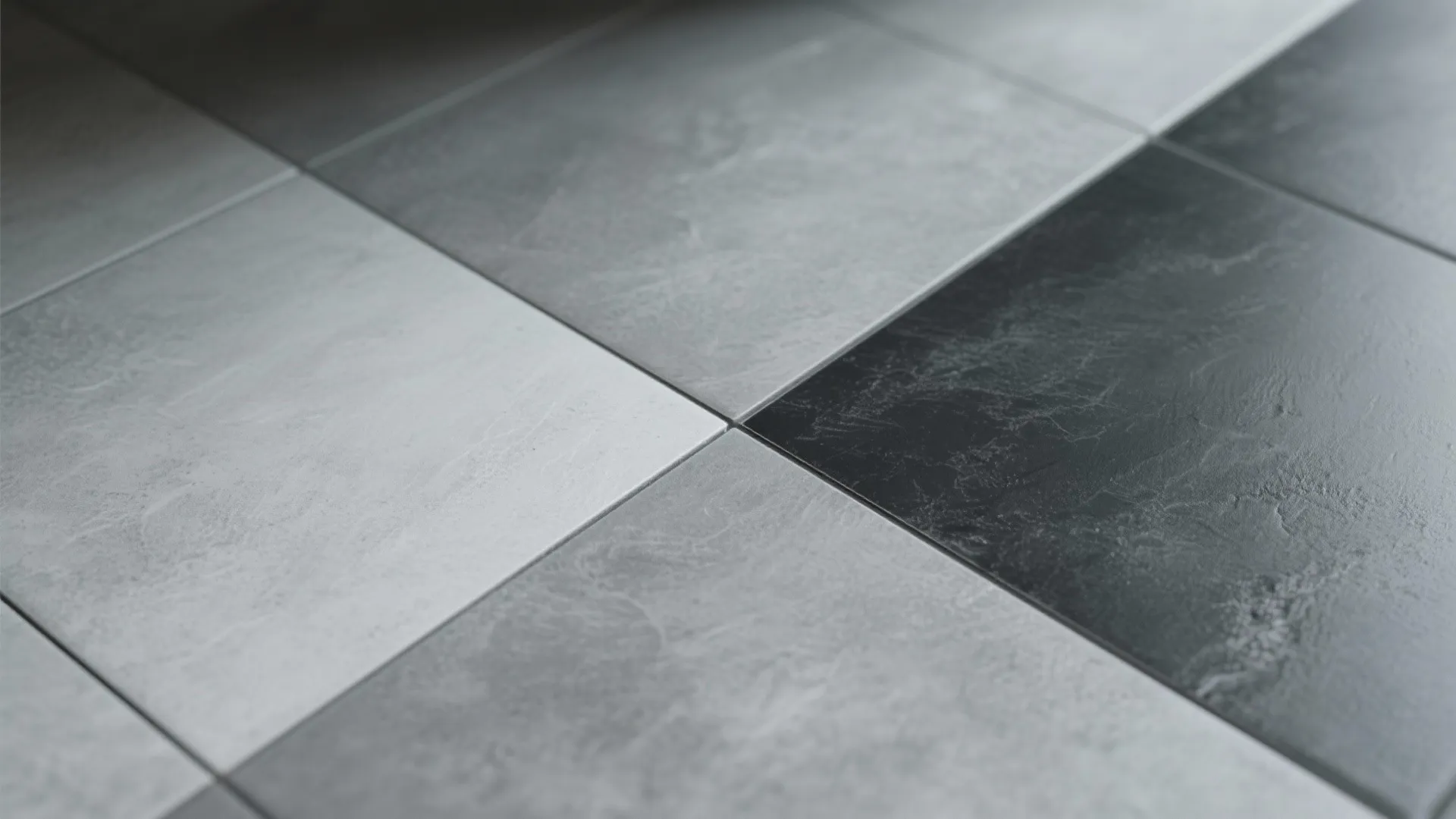 Close up of grey and black floor tiles with clean grout lines in a modern home