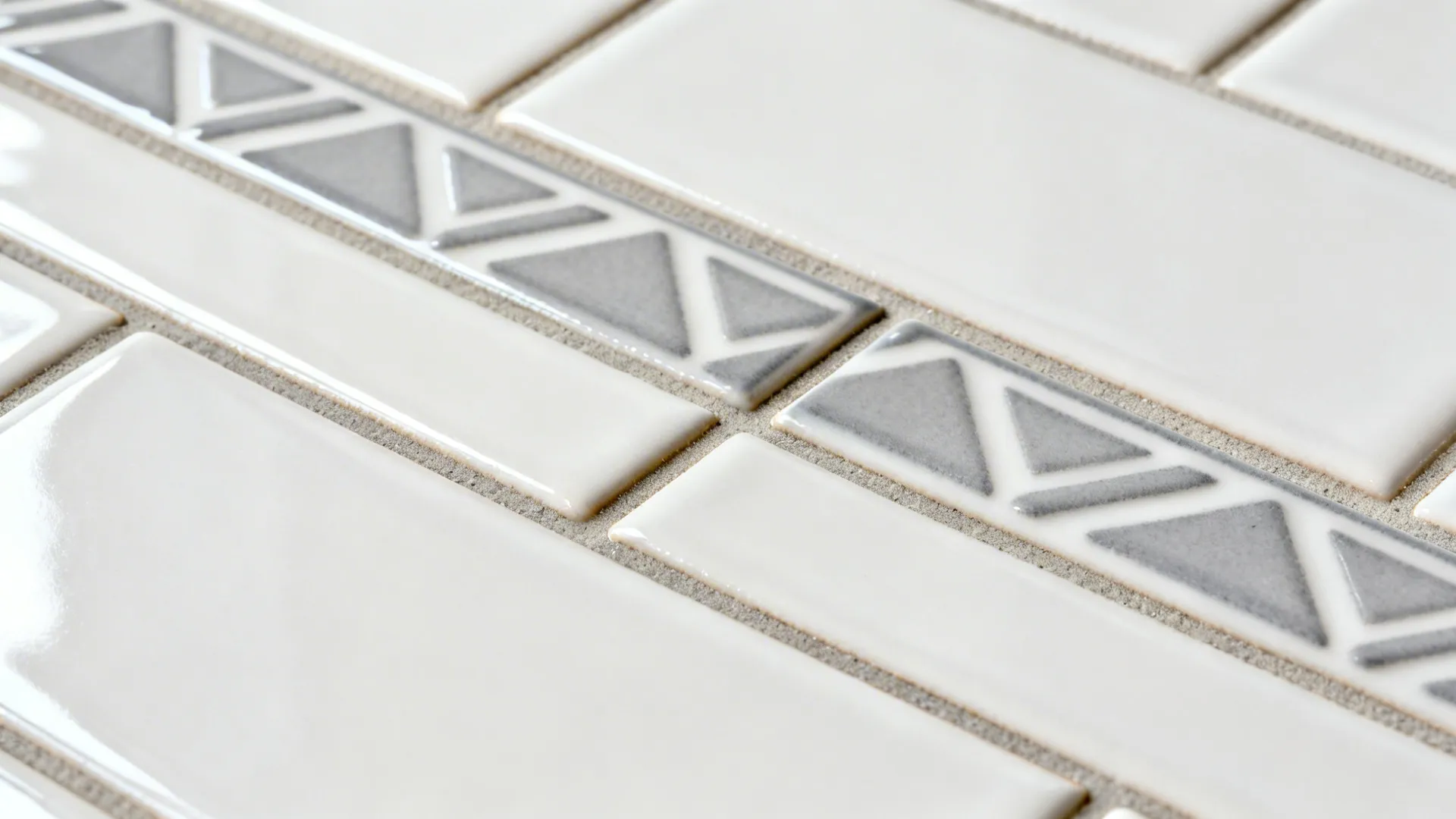 Macro view of subway tiles comparing color-matched grout, soft gray contrast grout, and 1/16-inch micro-joint.