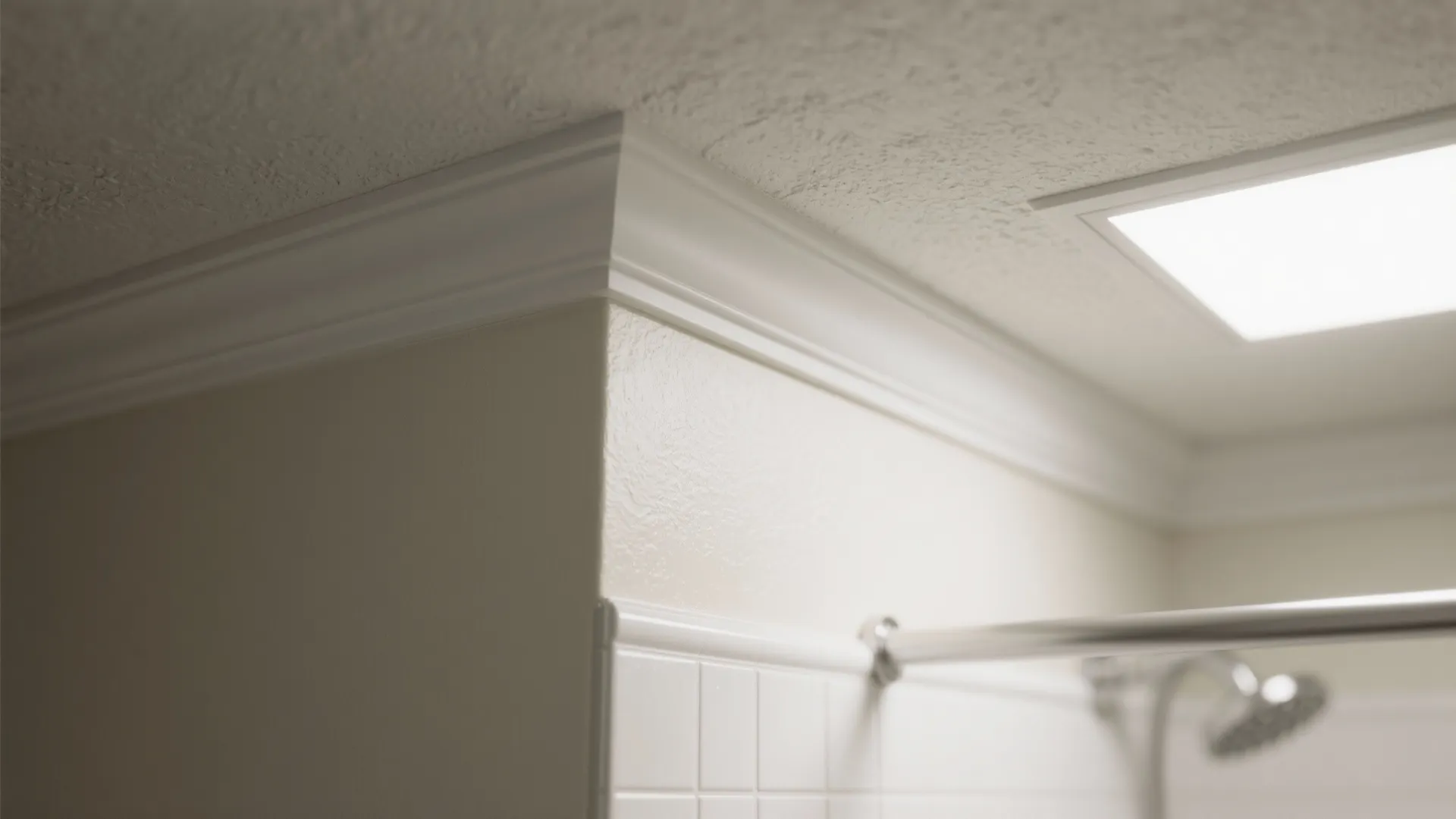 Close up of white wall panel decoration on ceiling with square light fixture and shower