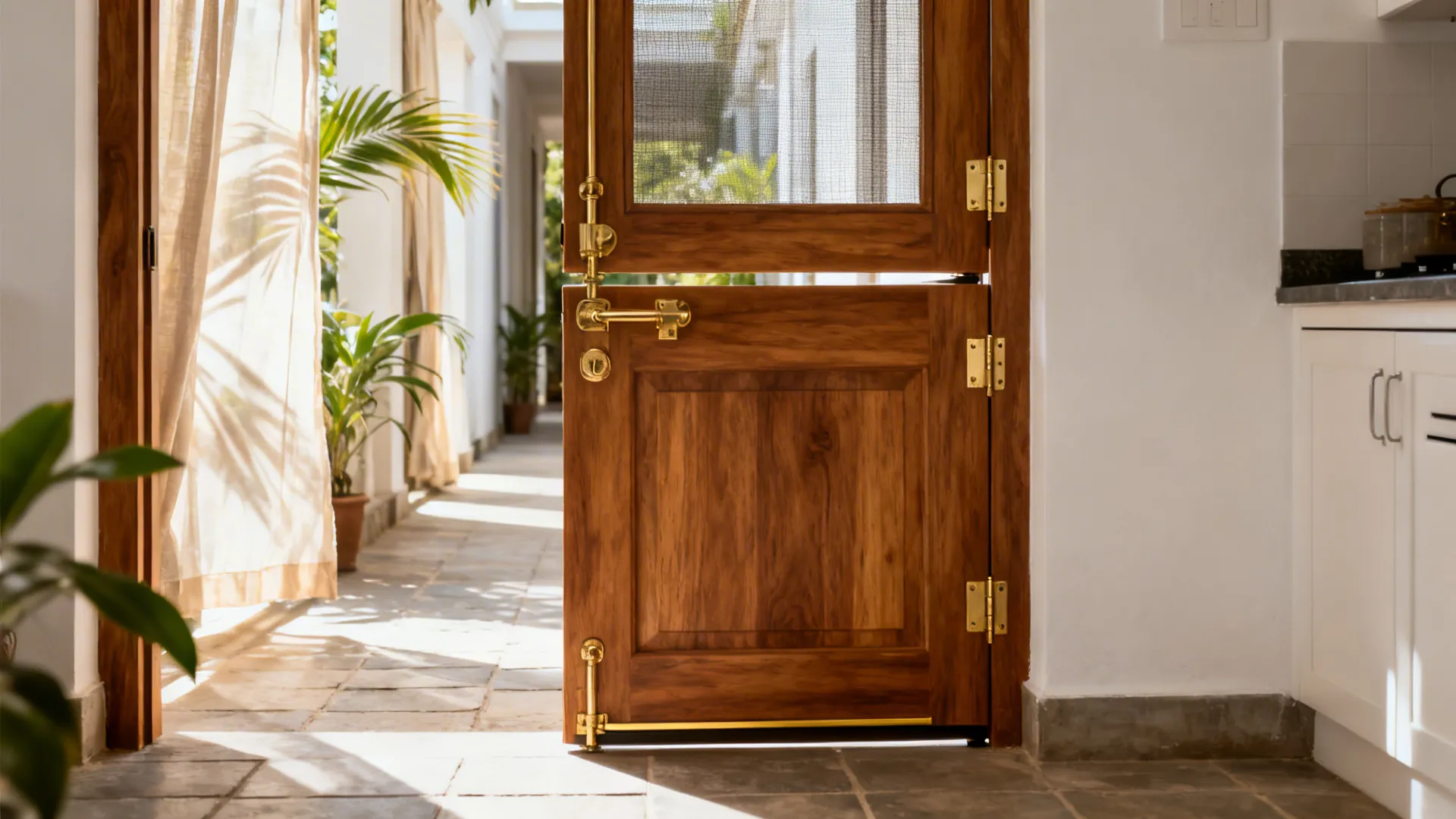Half-Dutch kitchen door with the top leaf open and bottom leaf latched in a Kerala home.