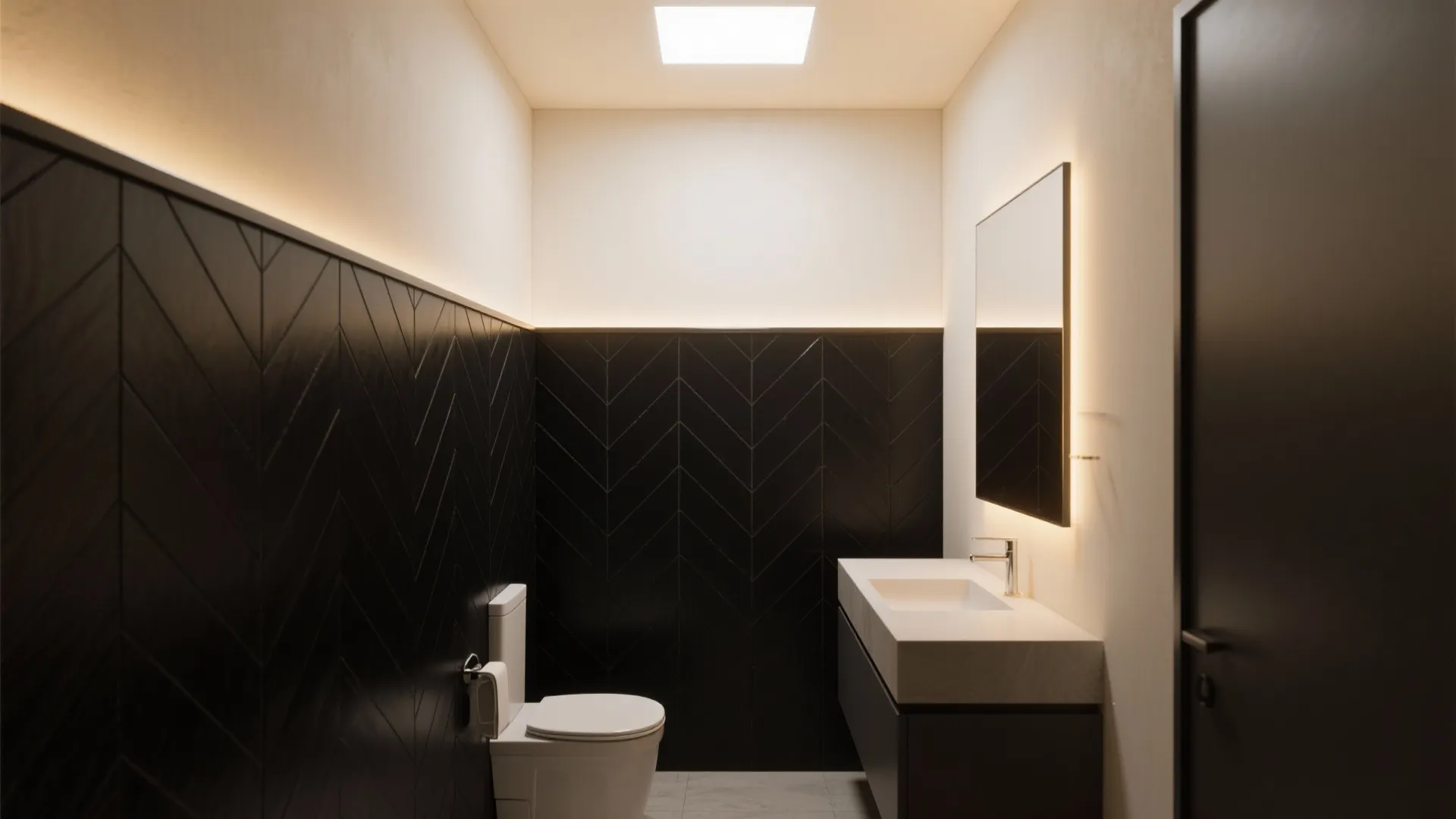 Narrow bathroom showing half-height black herringbone tile with painted warm off-white upper walls and slim metal trim.