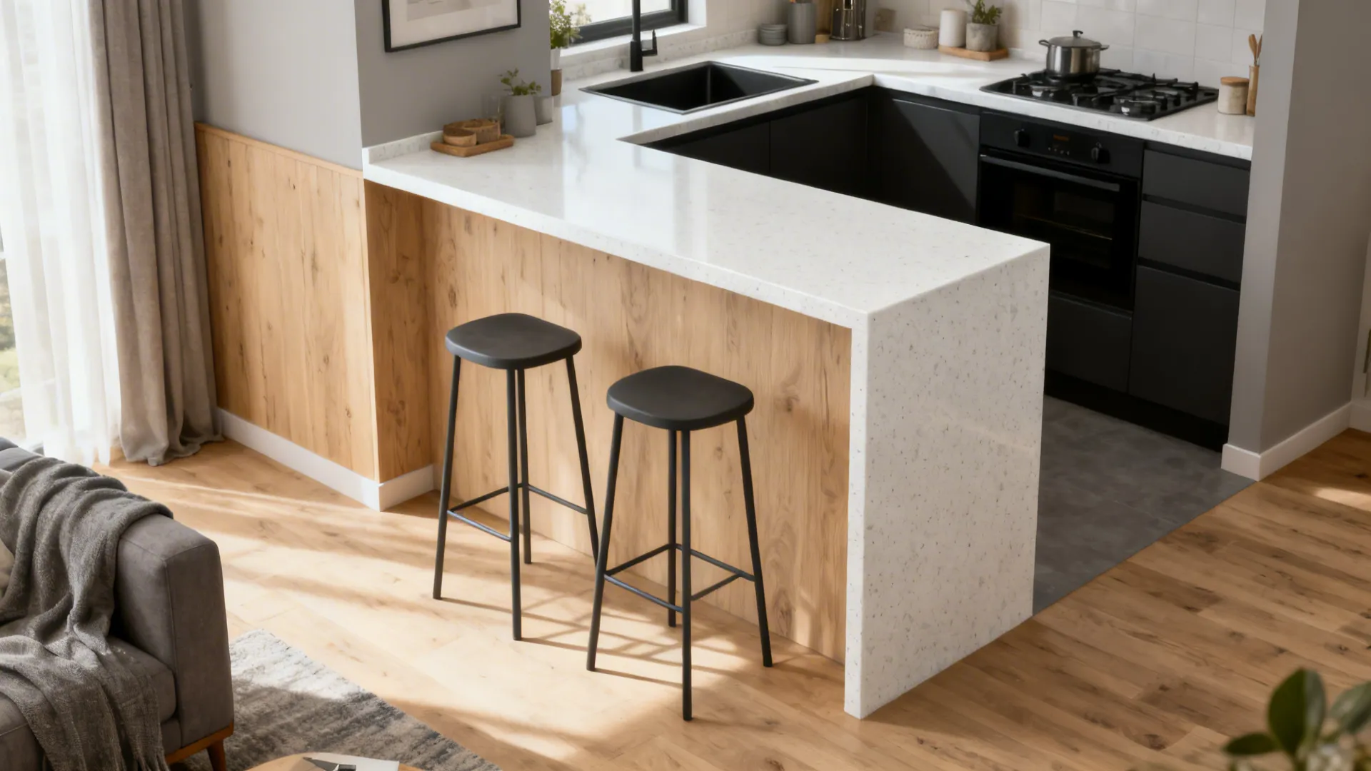 Modern kitchen featuring white stone breakfast bar two black stools wood wall panels and flooring