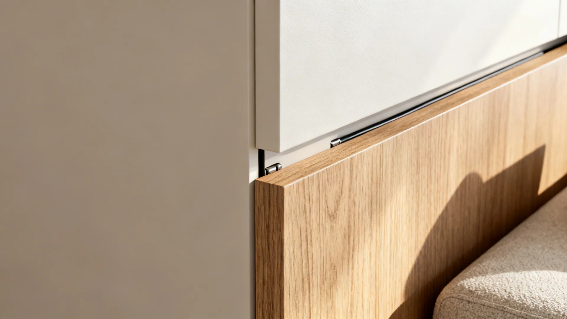 Close-up of half wall materials showing durable kitchen-facing finish and tactile living-room trim.