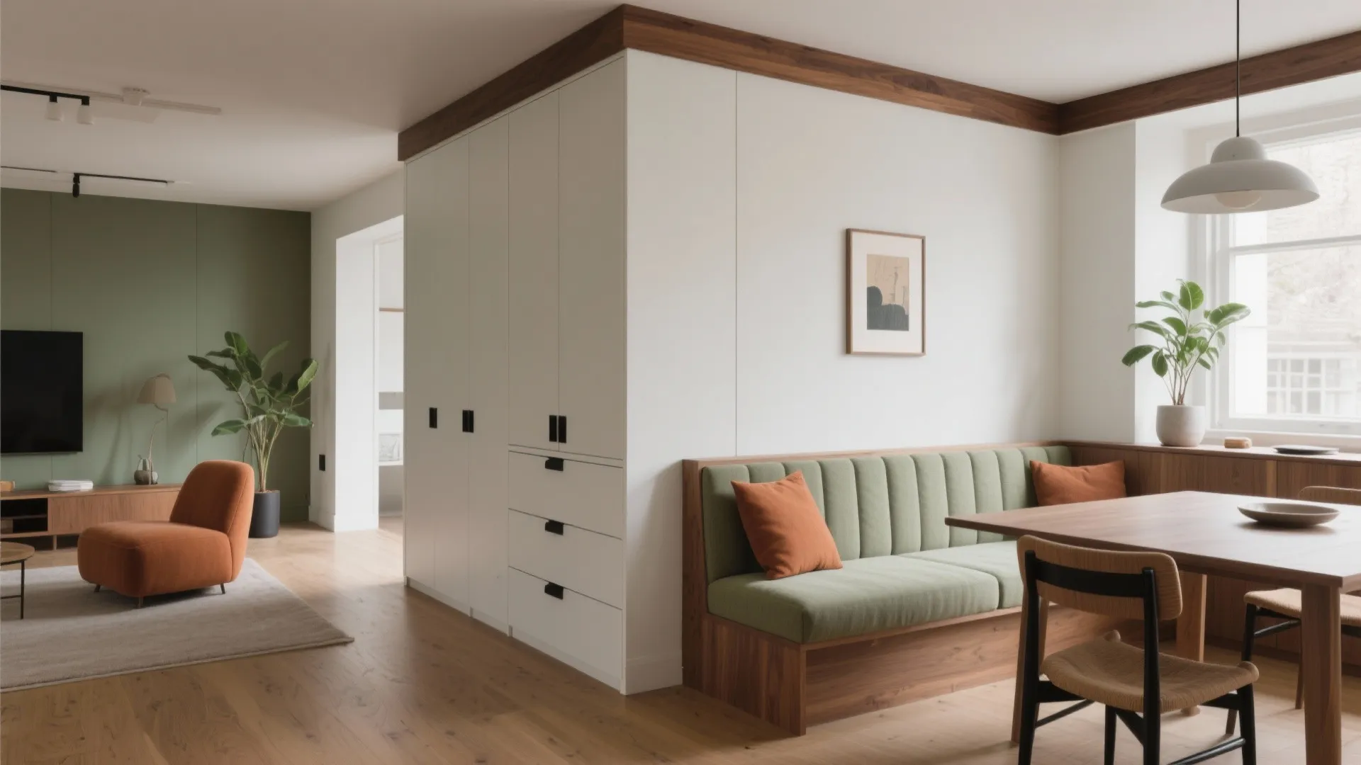 Low half wall with drawers and a built-in banquette defines dining from living with a clear 90 cm walkway.
