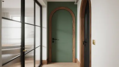 Elegant Hallway with Arched Green Door & Warm Wood Accents
