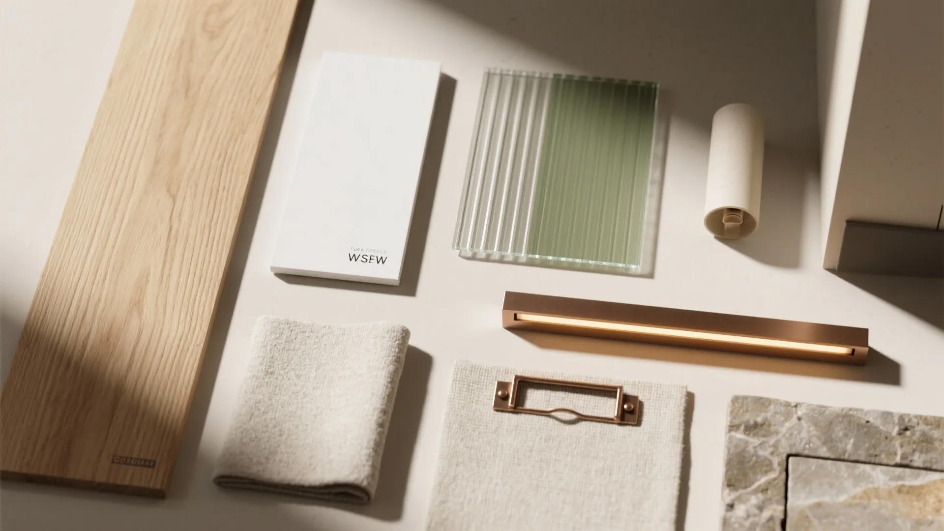 Modern interior design materials including wood, glass, fabric, metal light fixture, and natural stone tile