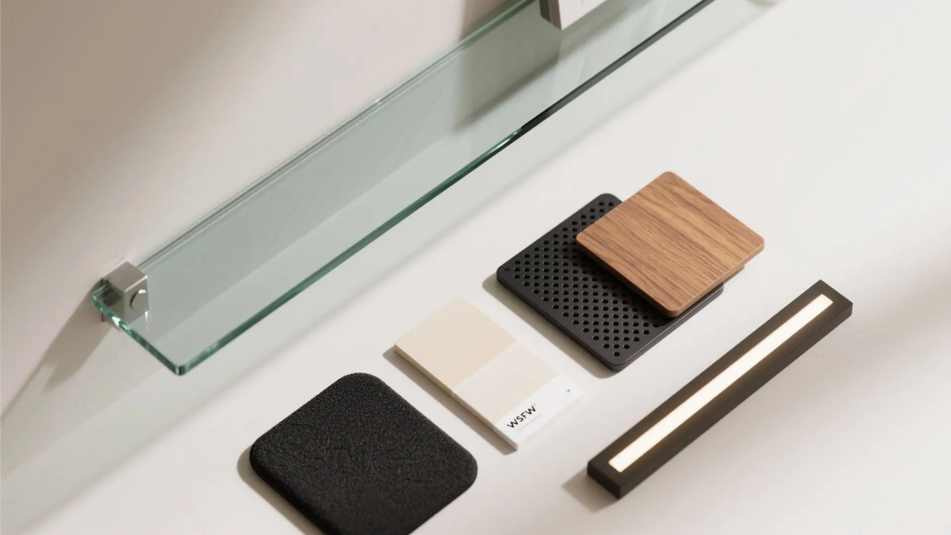 Flatlay of low-iron glass, perforated metal, oak veneer, paint chip, neoprene, and LED strip.