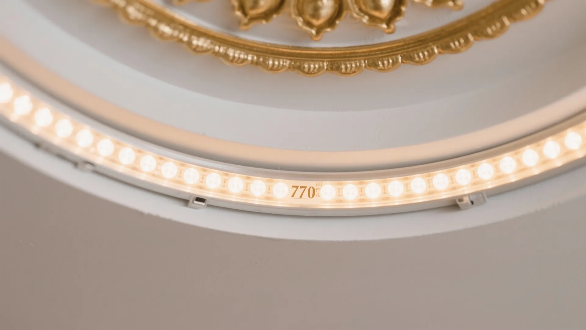 Close up of a warm led light strip installed within a circular white ceiling fixture