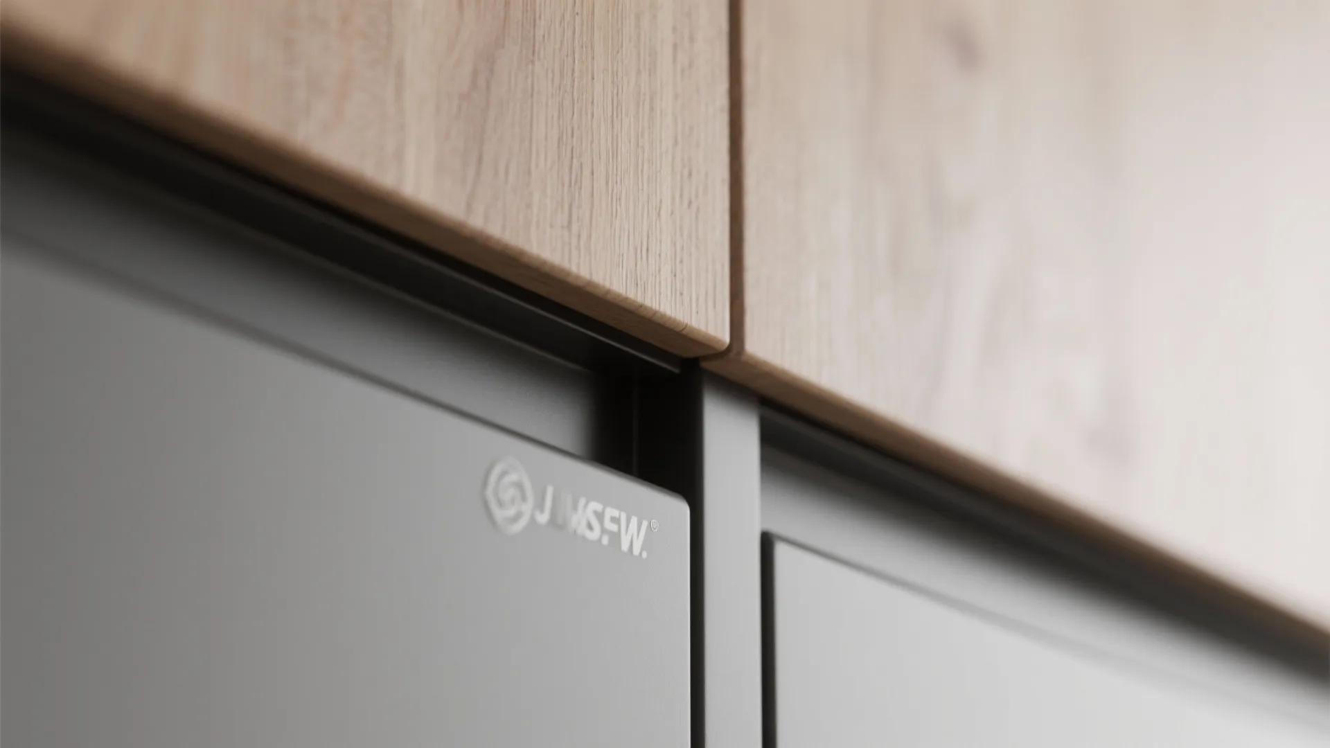 Macro view of a matte handleless cabinet edge with J-groove and clean ABS edging.