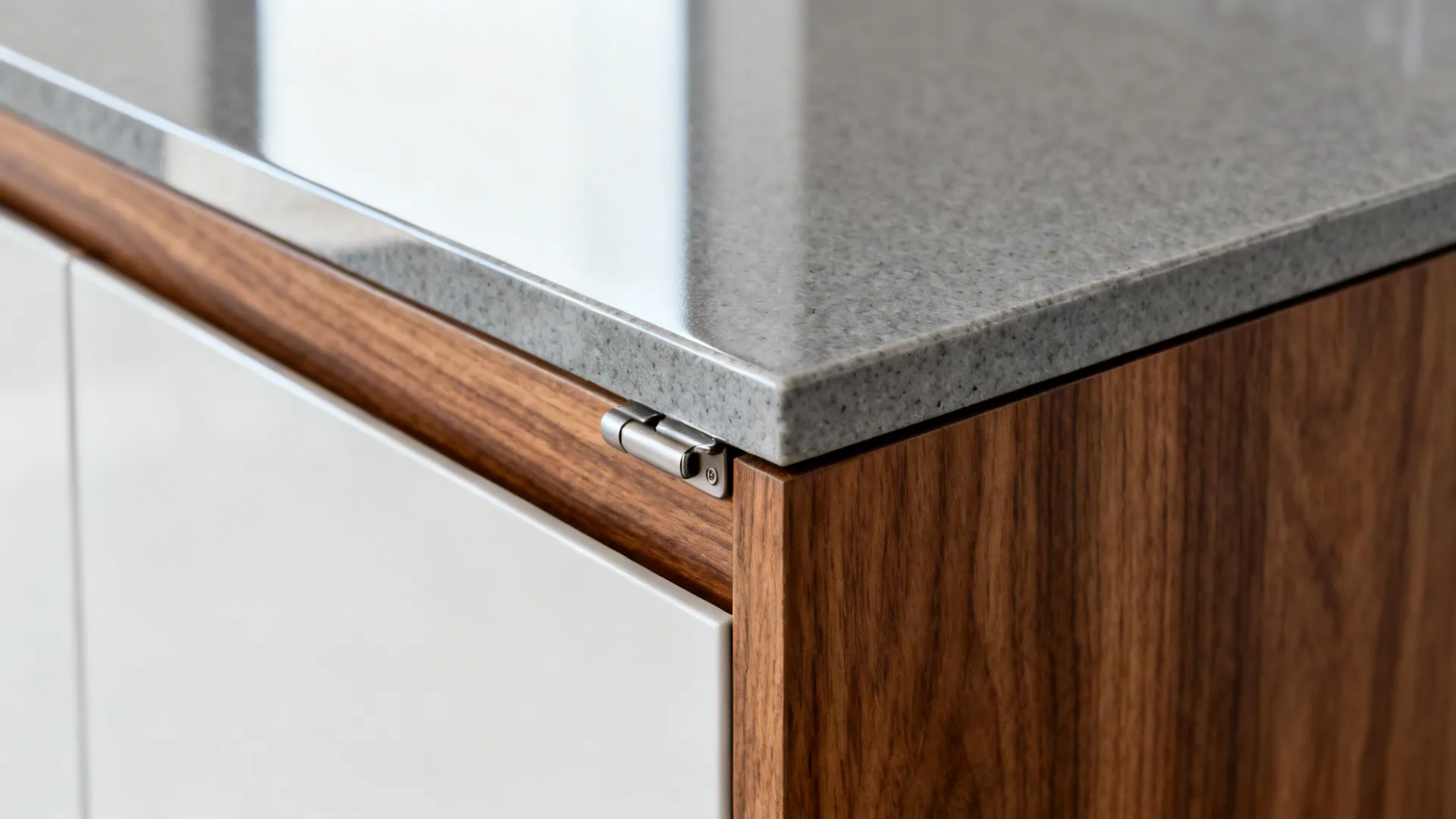 Macro of handle-less cabinet edge with soft-close hinge and quartz counter detail