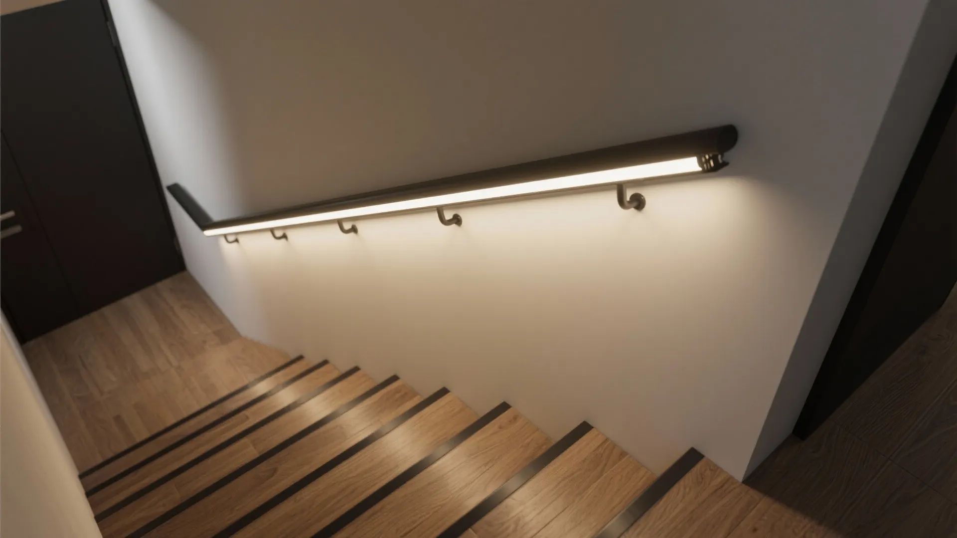 Top-down view of a staircase handrail with an integrated linear LED channel providing continuous guidance.