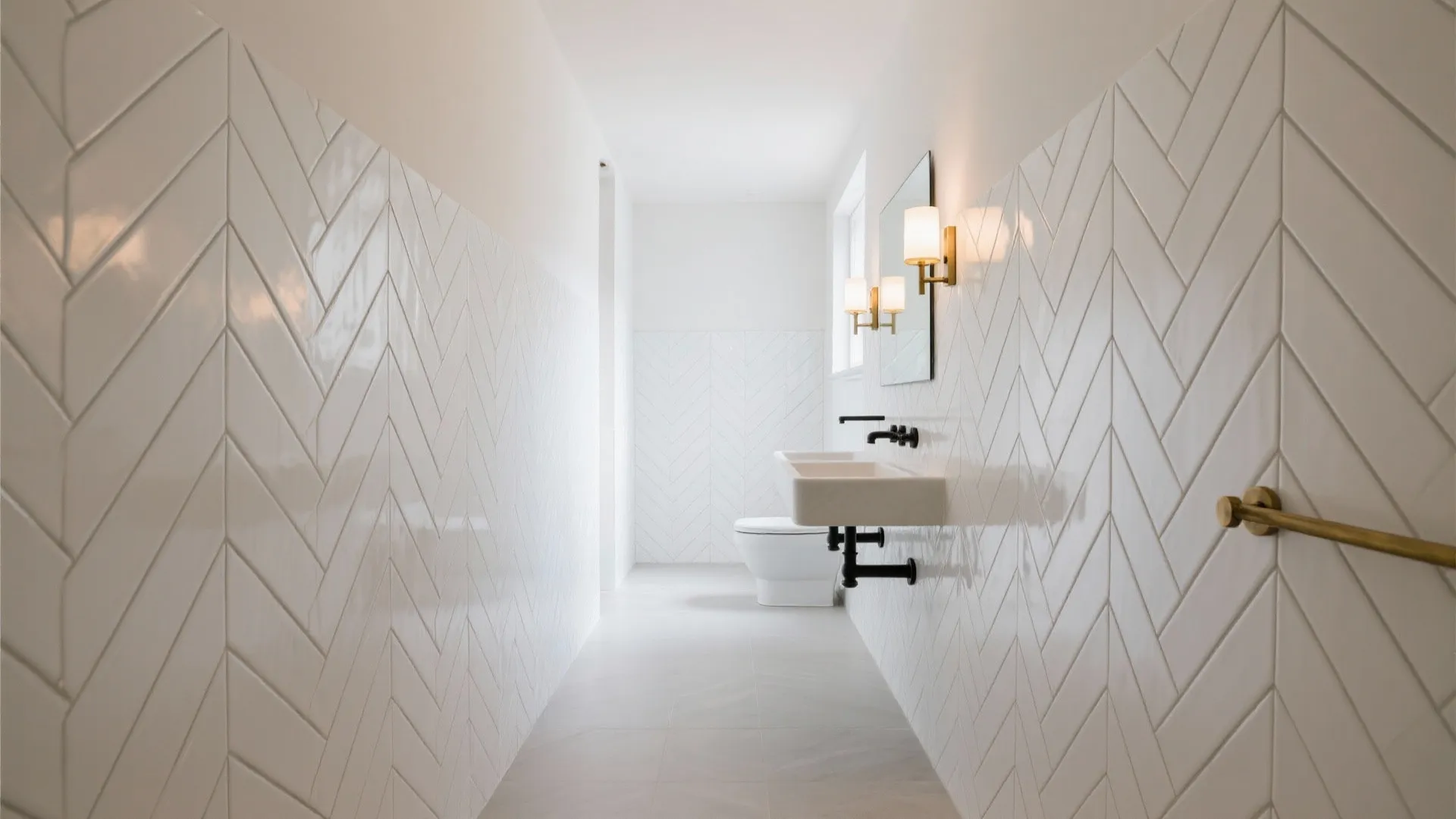 Bright white bathroom featuring glossy wall tiles in a chevron pattern with gold light fixtures