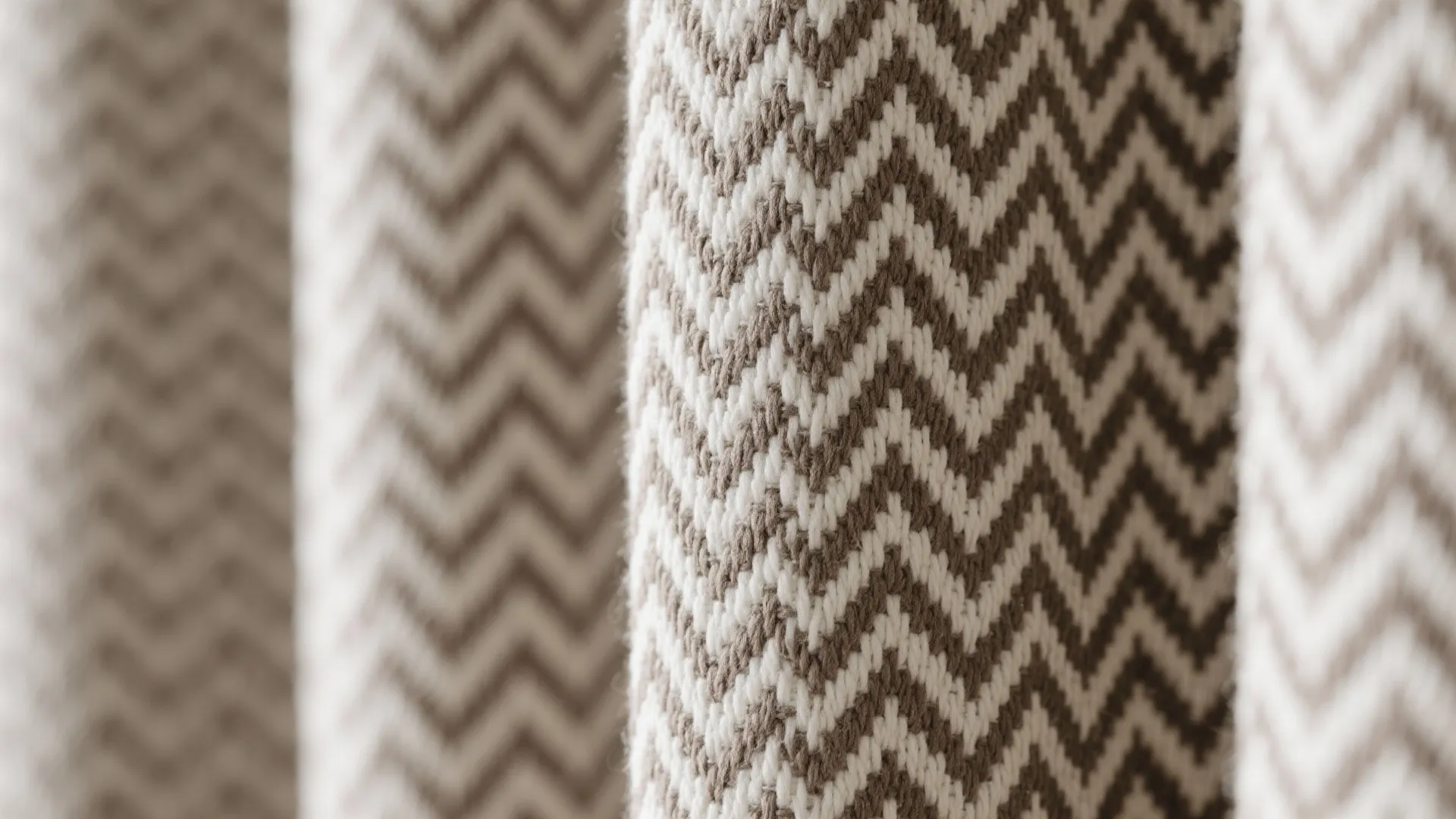 Macro of micro-herringbone curtain fabric in taupe and ivory with precise seam alignment.