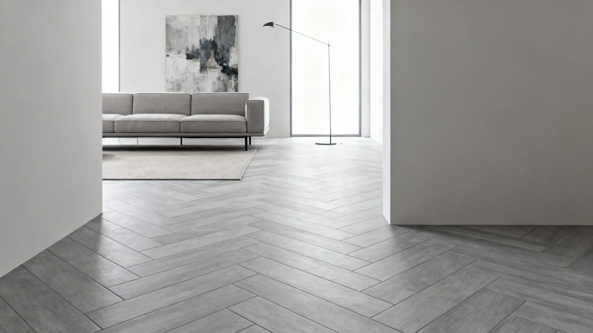 Herringbone patterned gray porcelain tiles elongate a modern living room.