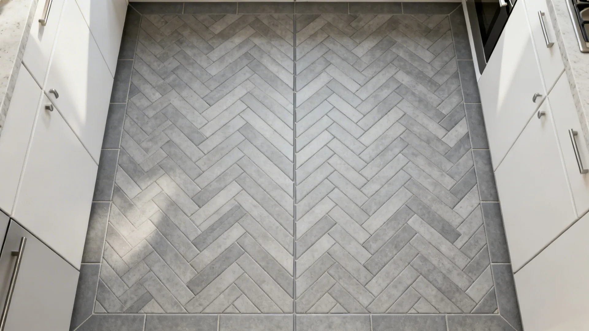 Top-down plan of slim grey tiles in a herringbone layout with clean cuts.