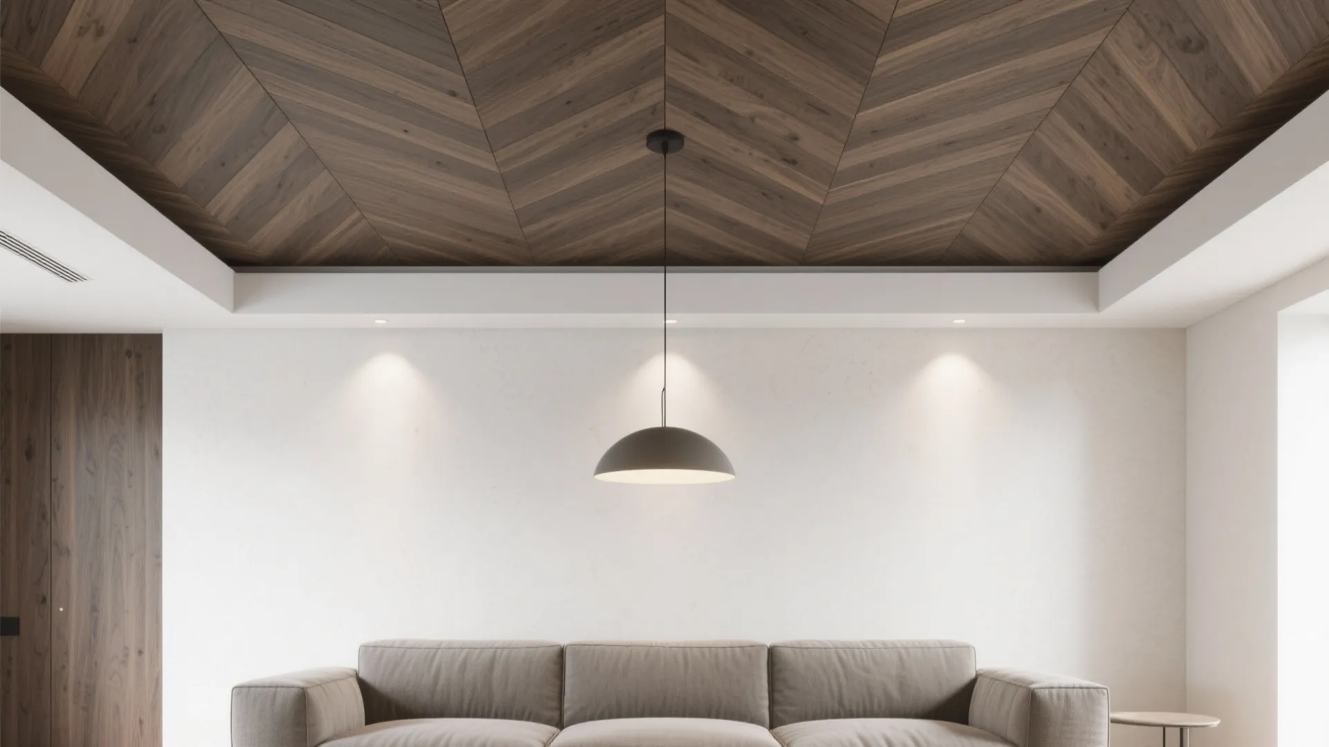 Living room with chevron wood veneer ceiling feature zone above the sofa.