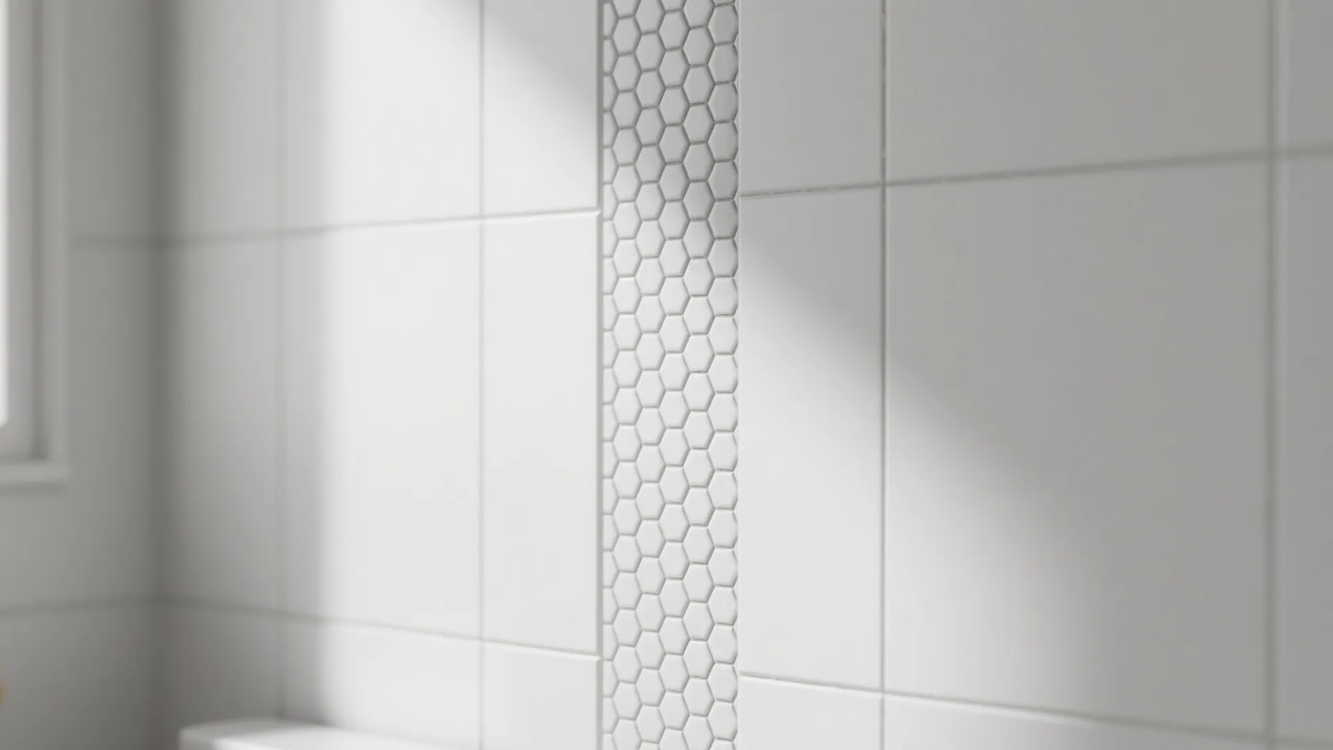 Close up of white wall tiles with a vertical stripe of small hexagon shaped tiles