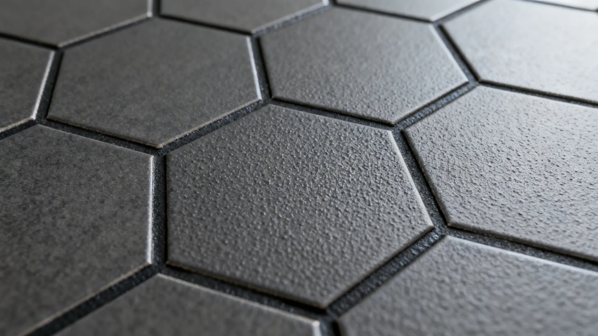 Macro view of matte hex tile surface showing slip-resistant texture and grout.