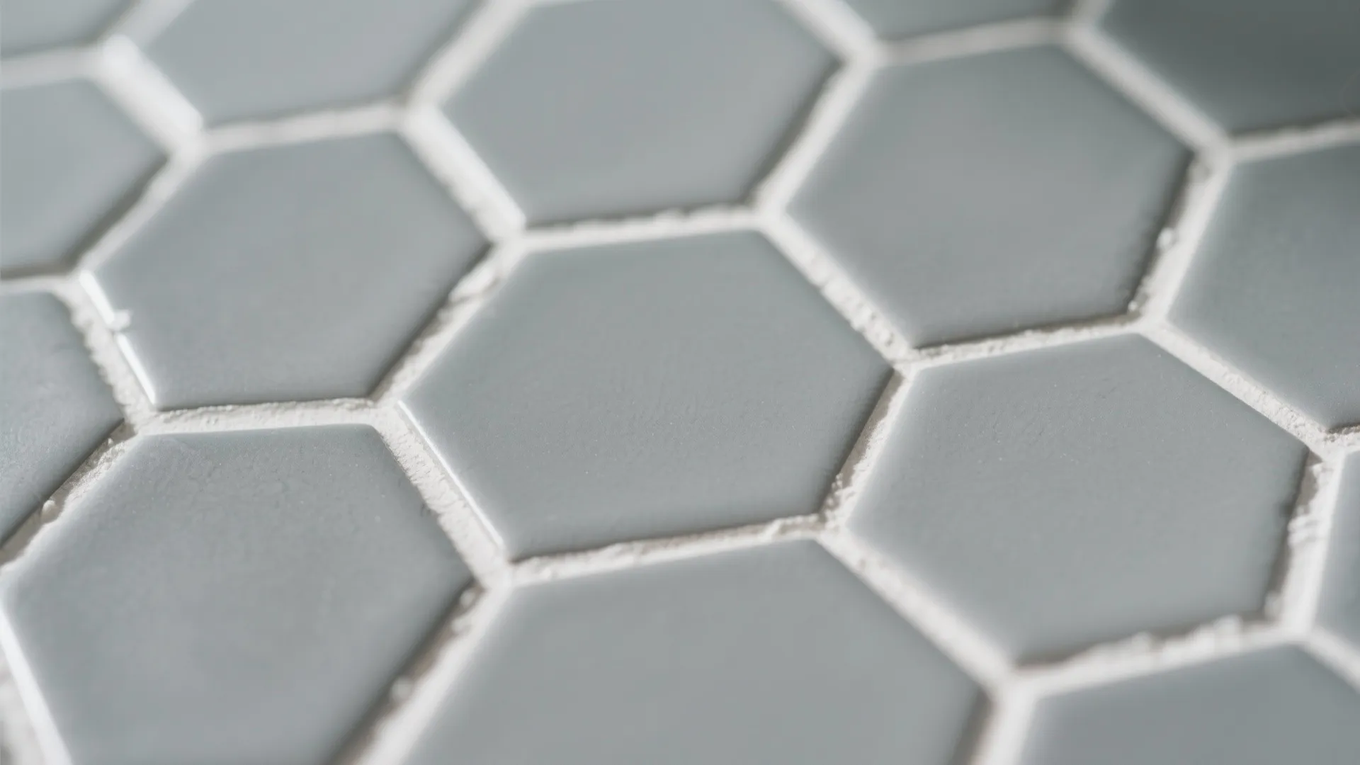 Close up view of blue hexagon wall tiles with white grout in a modern bathroom design