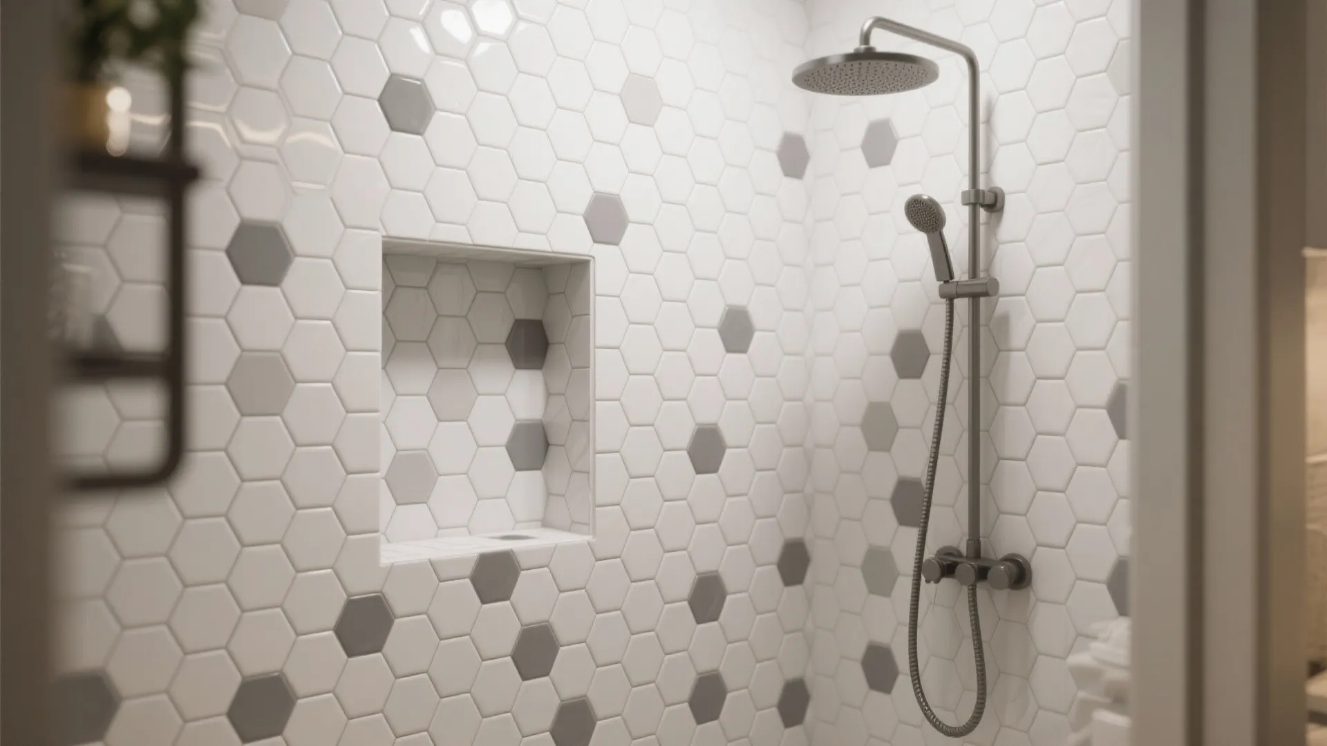 Shower area with white and grey hexagon wall tiles and a silver metal shower head