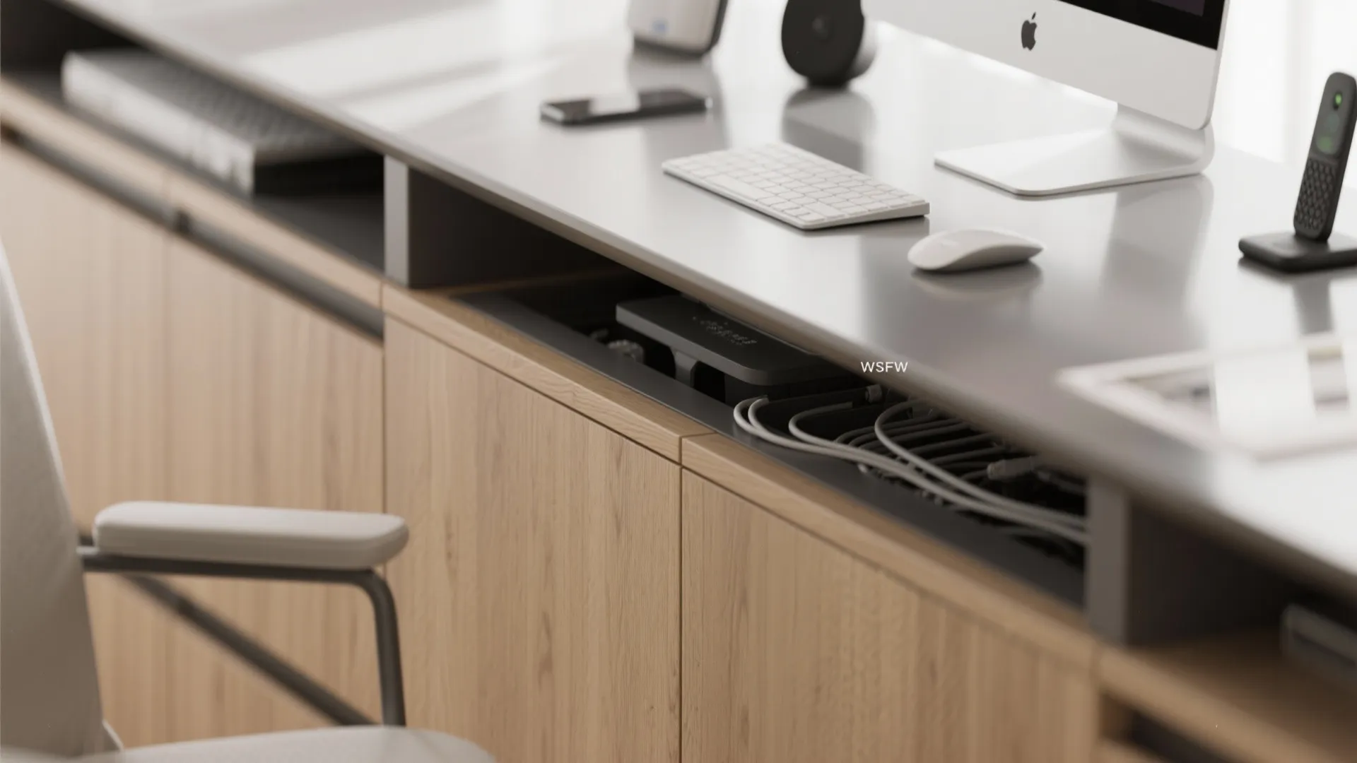 Close-up of desk with hidden cable management compartment