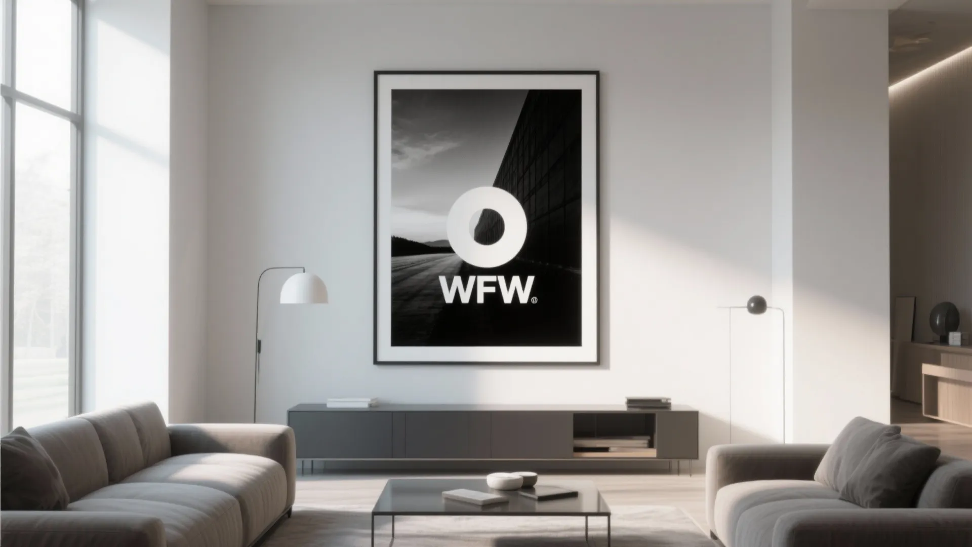 Minimalist living room with grey sofas square coffee table large black framed wall art and windows