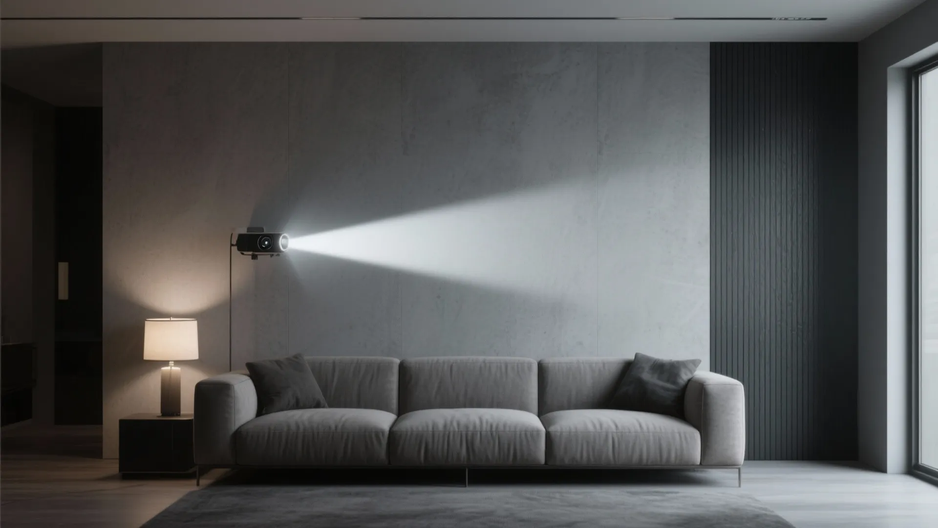 Grey sofa against a concrete wall with a projector light beam and a small table lamp