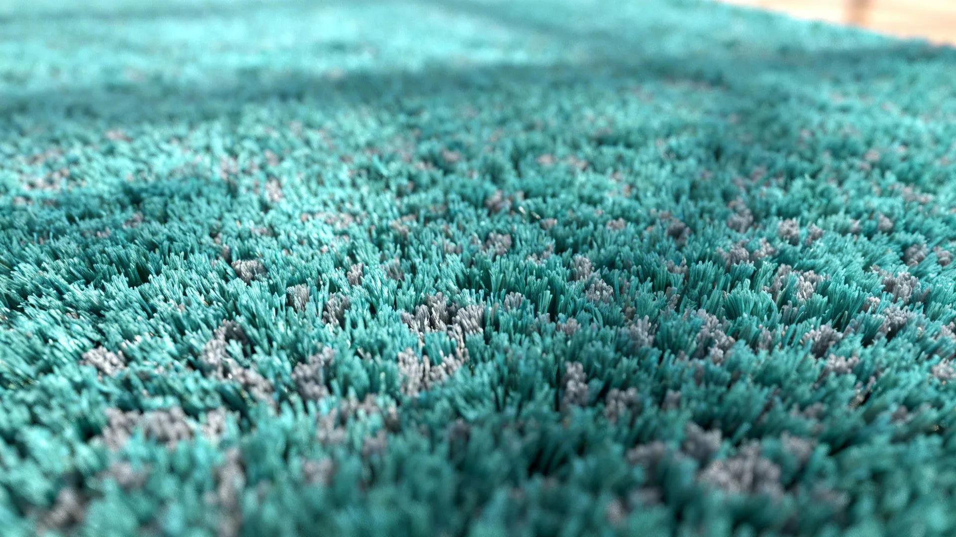Close-up of a plush high-pile teal rug with grey flecks showing rich texture.