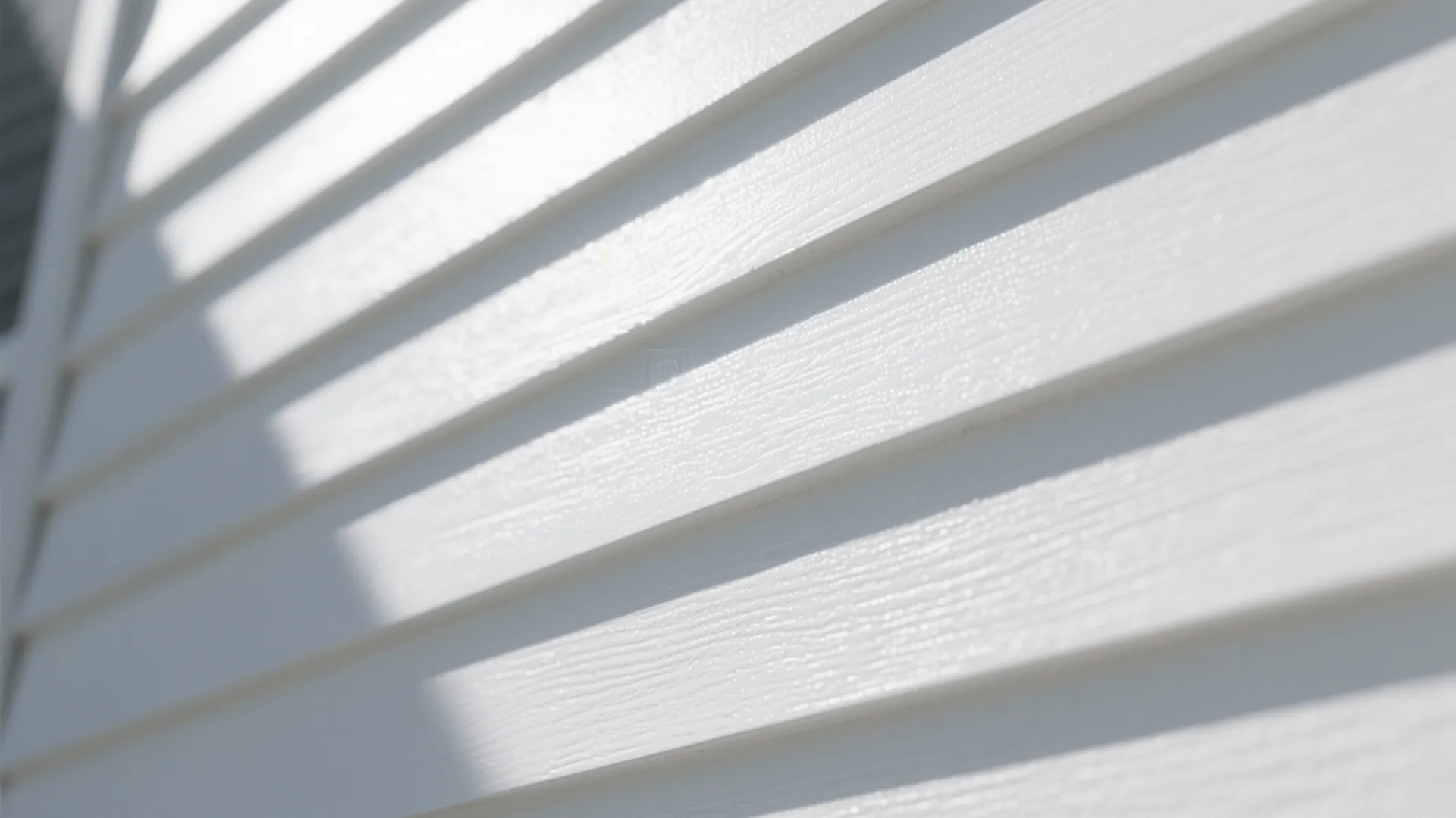 Close up view of white wall panels with textured surface and soft shadows in sunlight